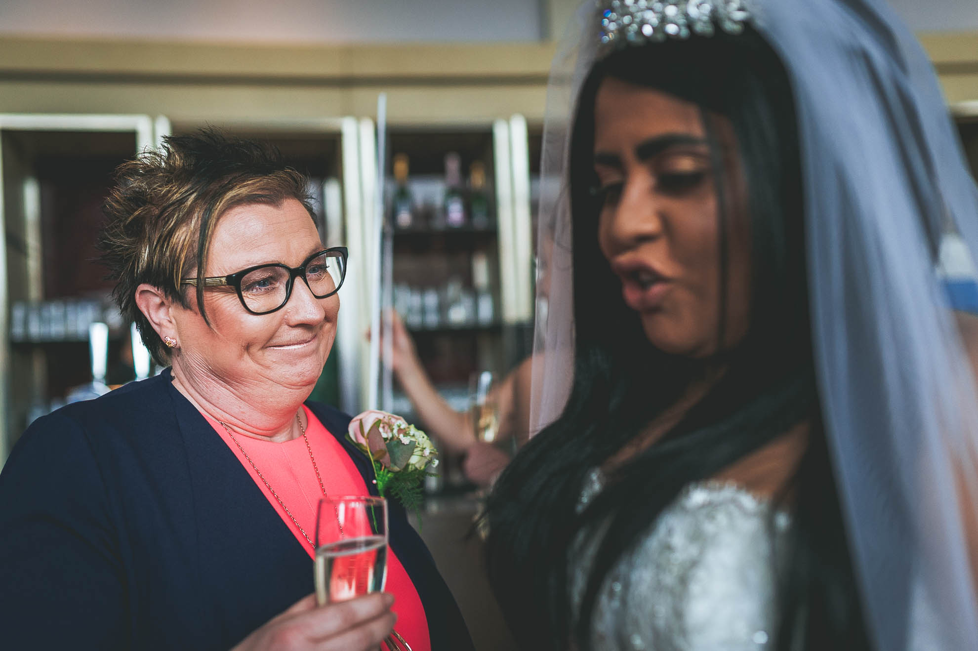 mother of the bride smiles at bride