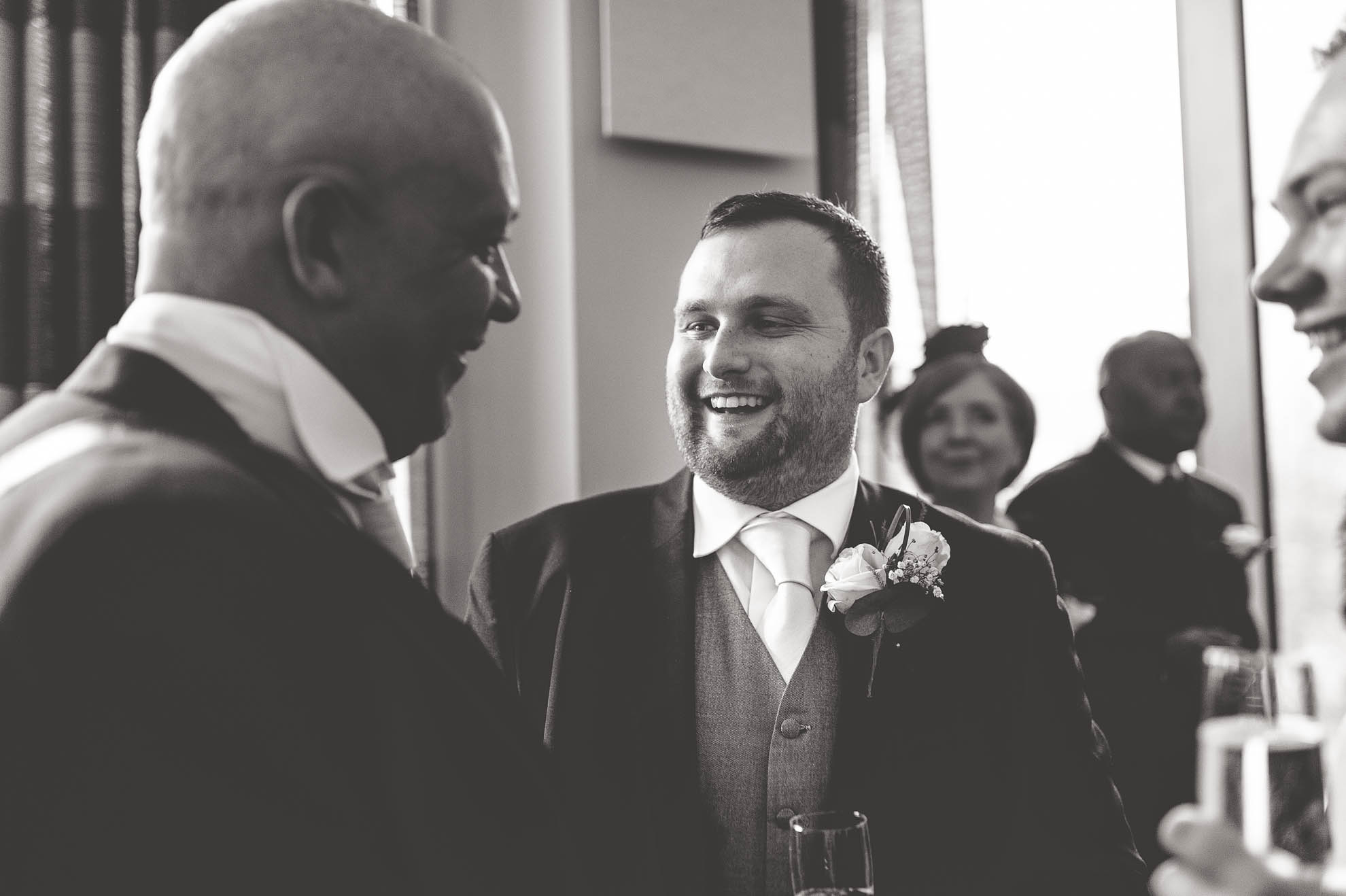 groom shares a joke with father of the bride