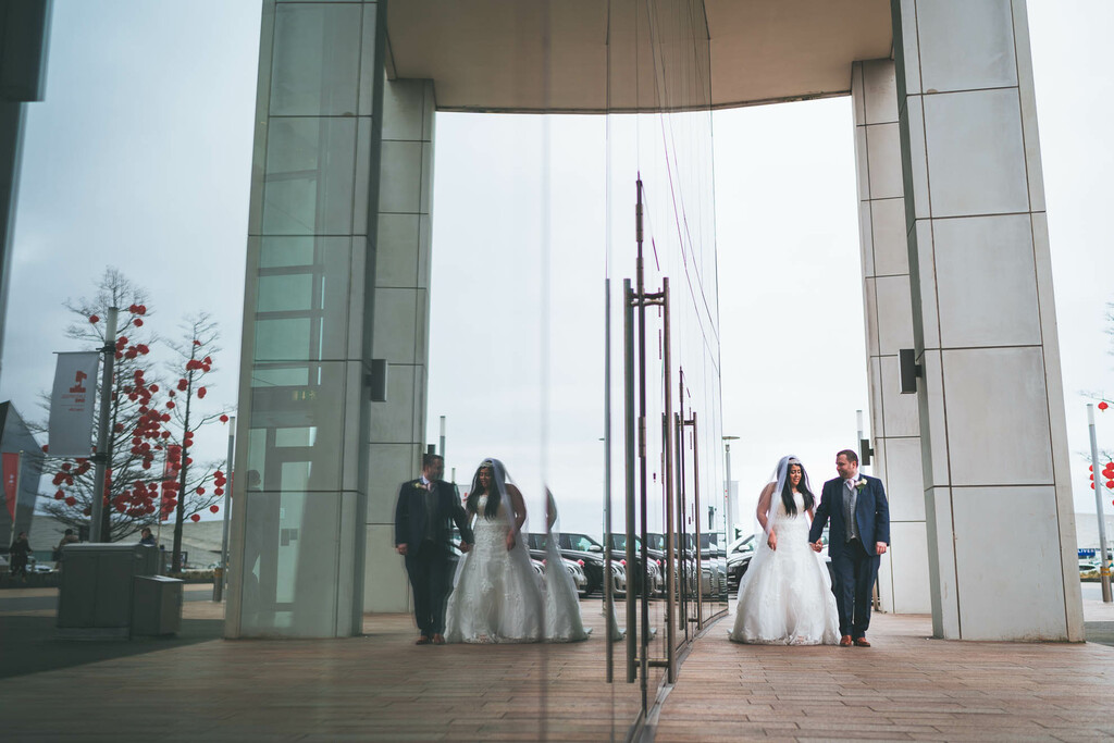 bride and groom reflected in the hilton liverpool