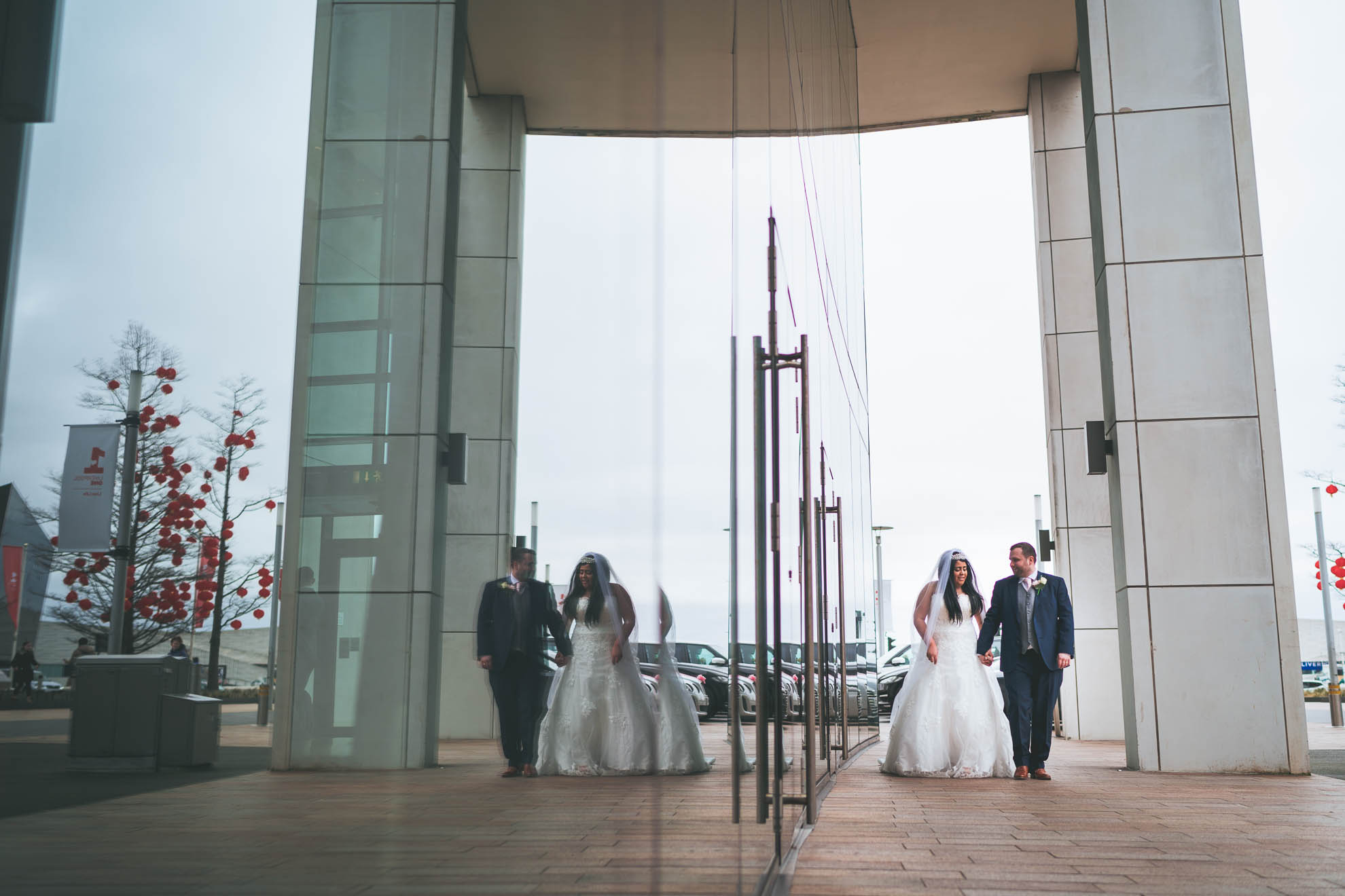bride and groom reflected in the hilton liverpool