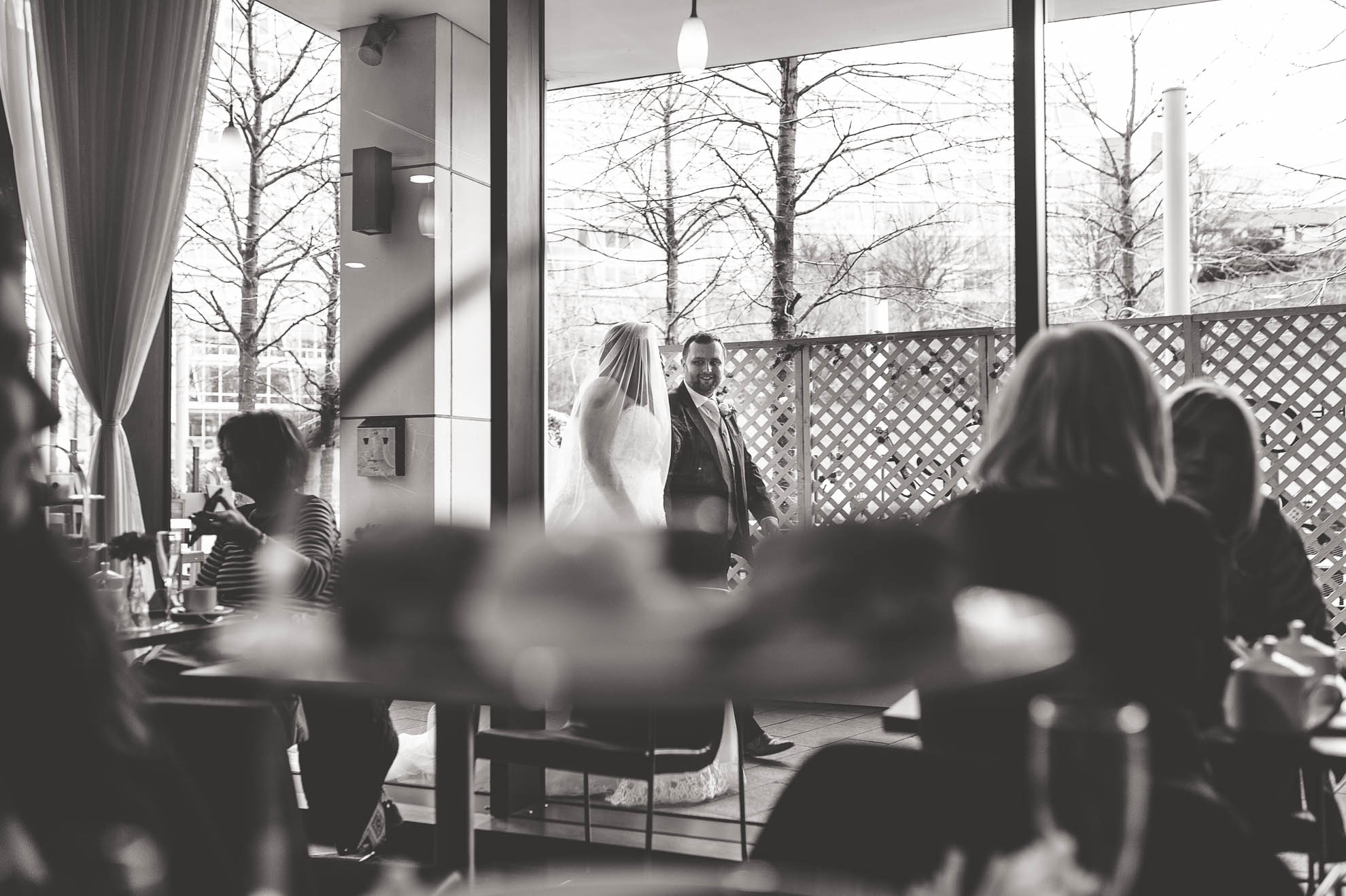 bride and groom shot through a window