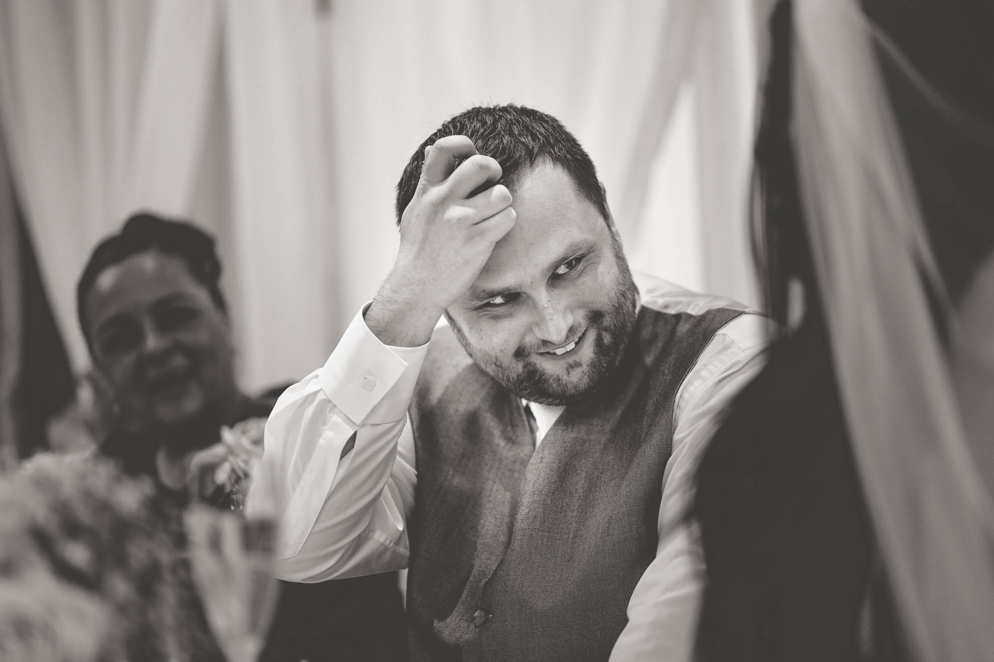 groom slightly embarrassed by best mans speech 