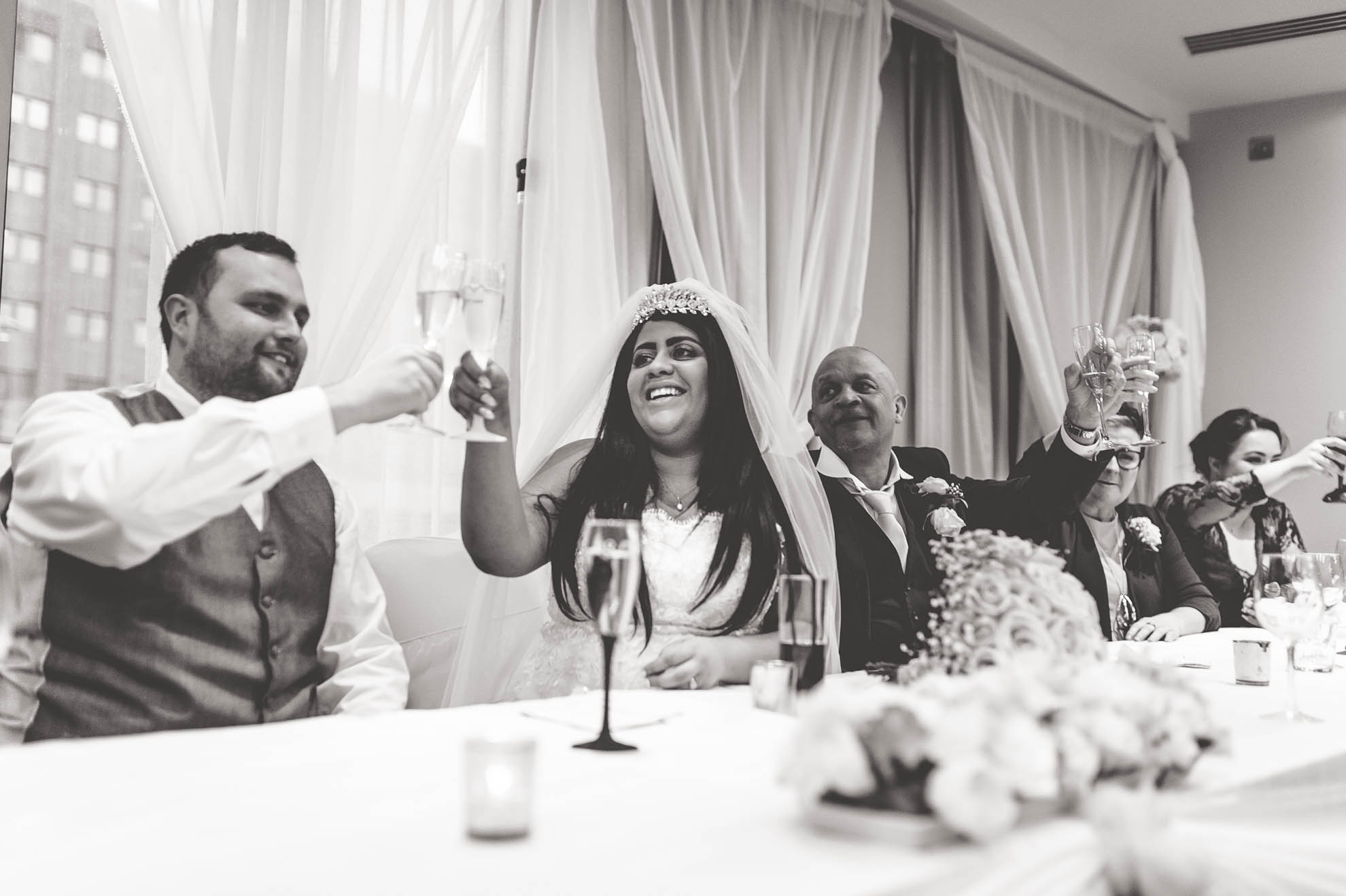 bride and groom raising their glasses
