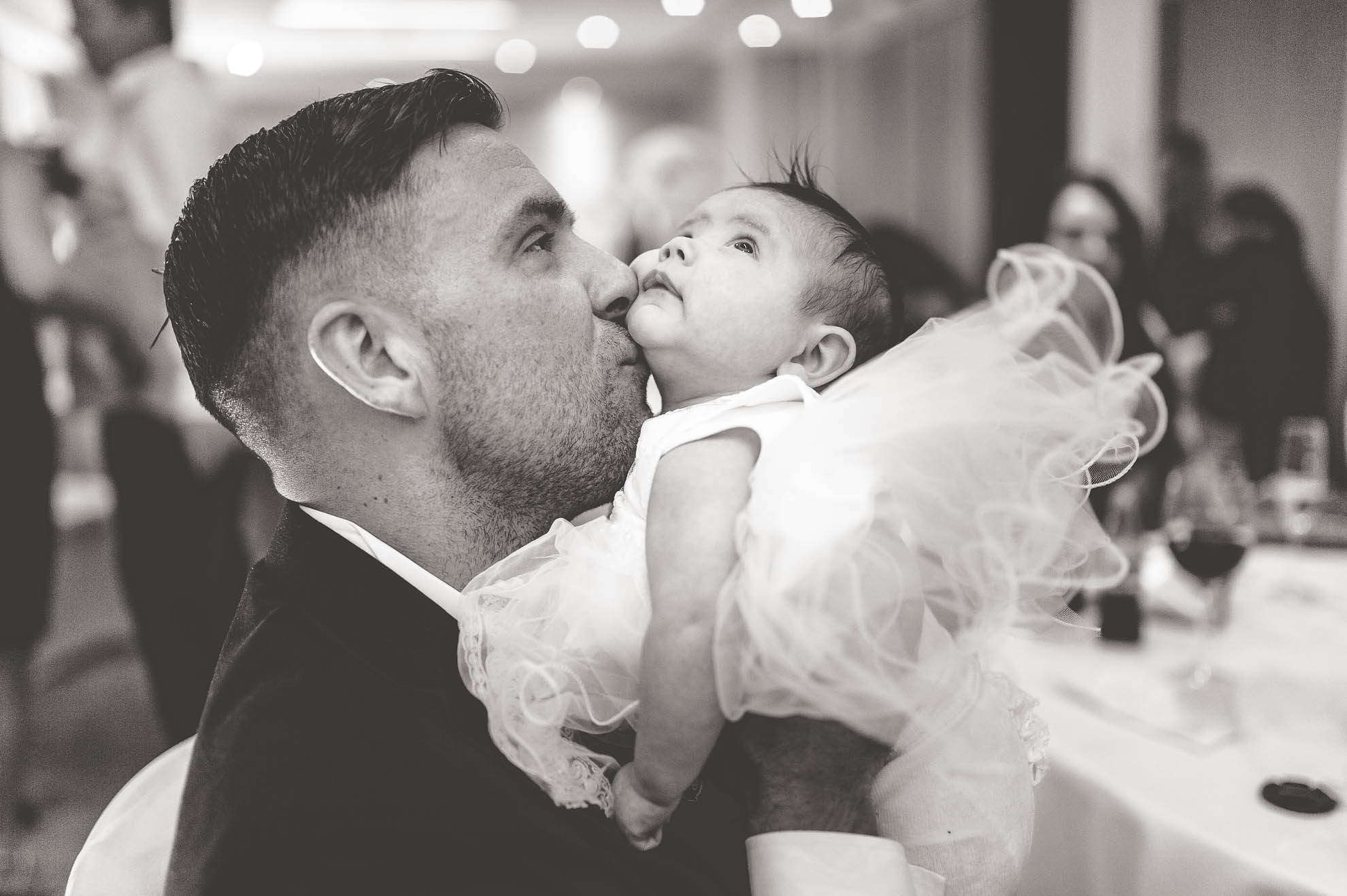 dad kisses baby daughter