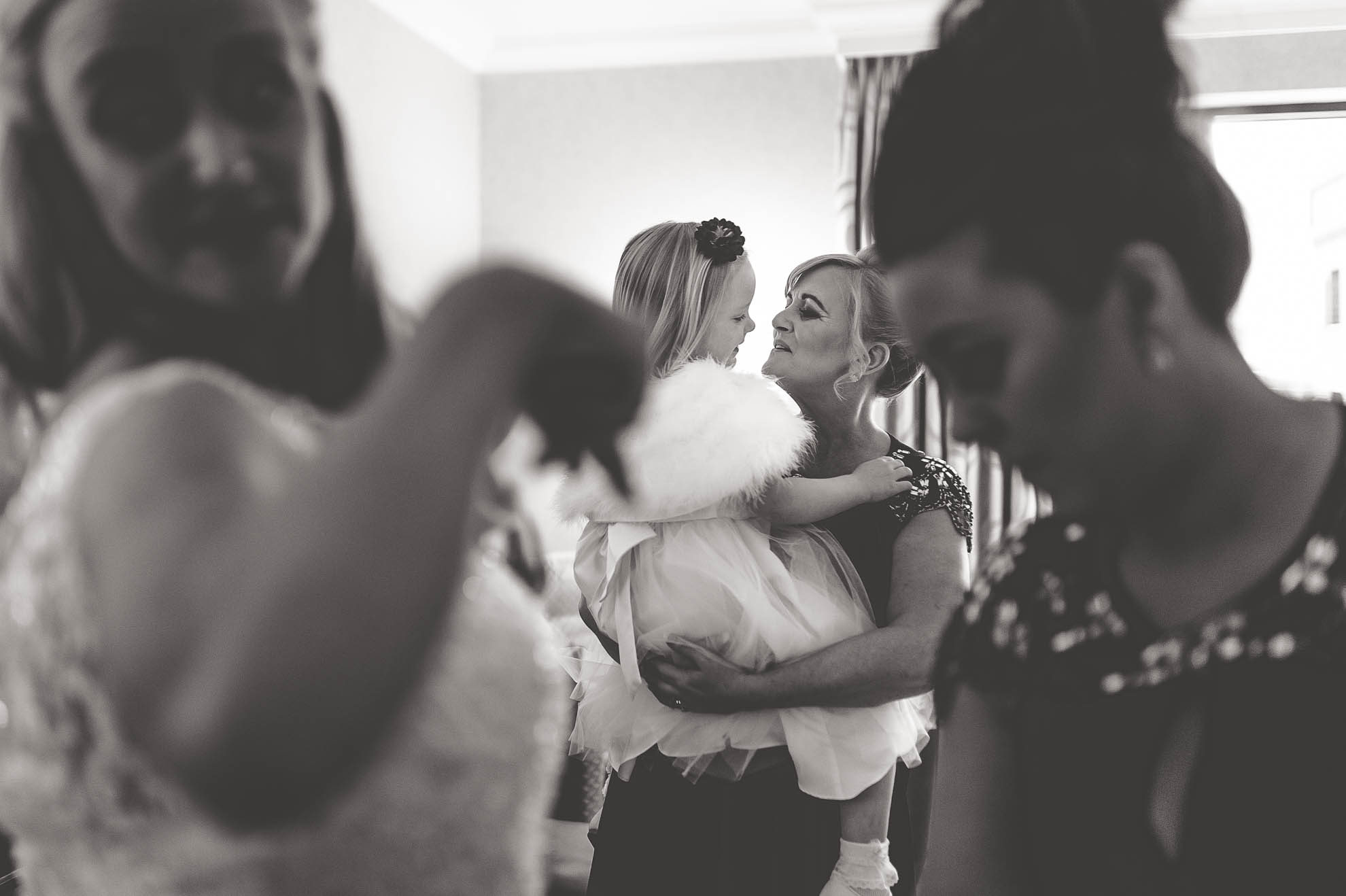 bridesmaid holding flower girl