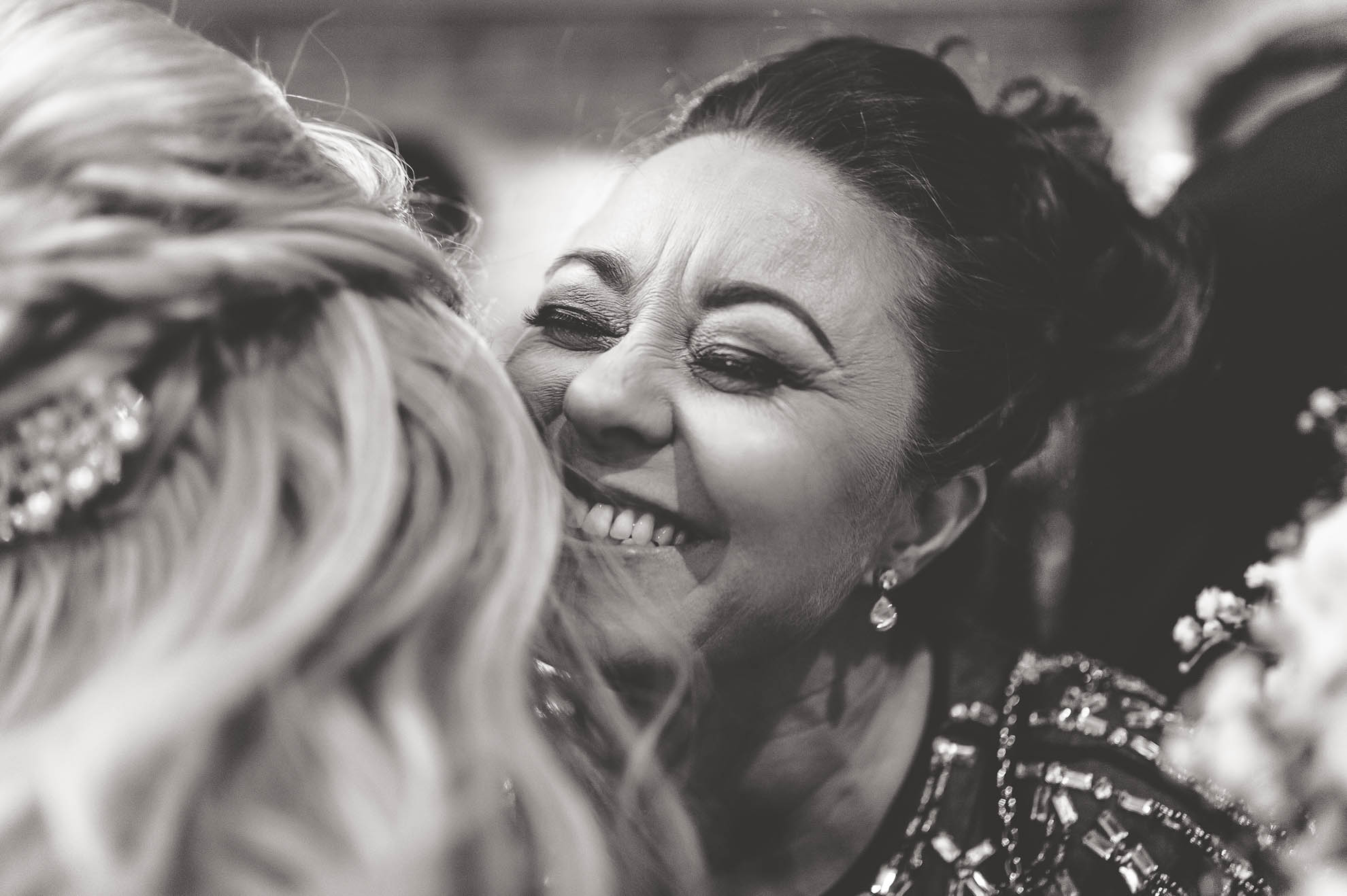 bridesmaid hugging bride