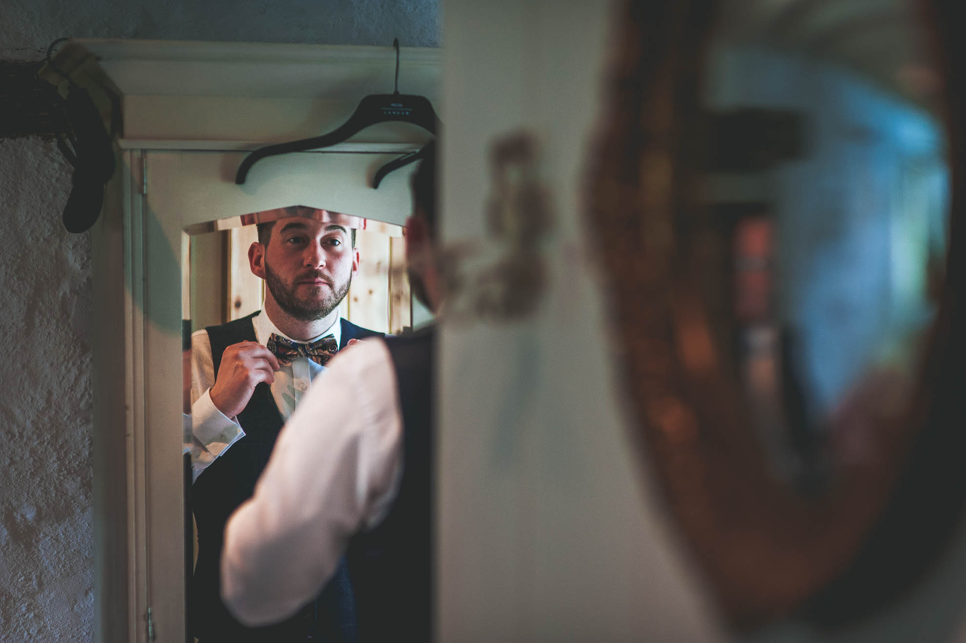 groom adjusts tie