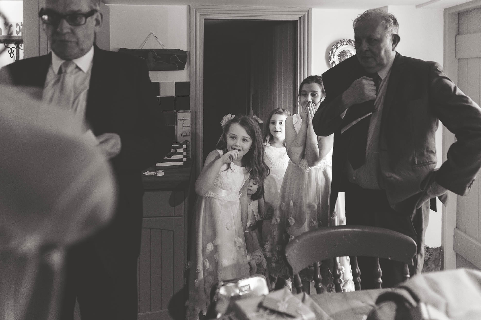 flower girls look at the wedding dress