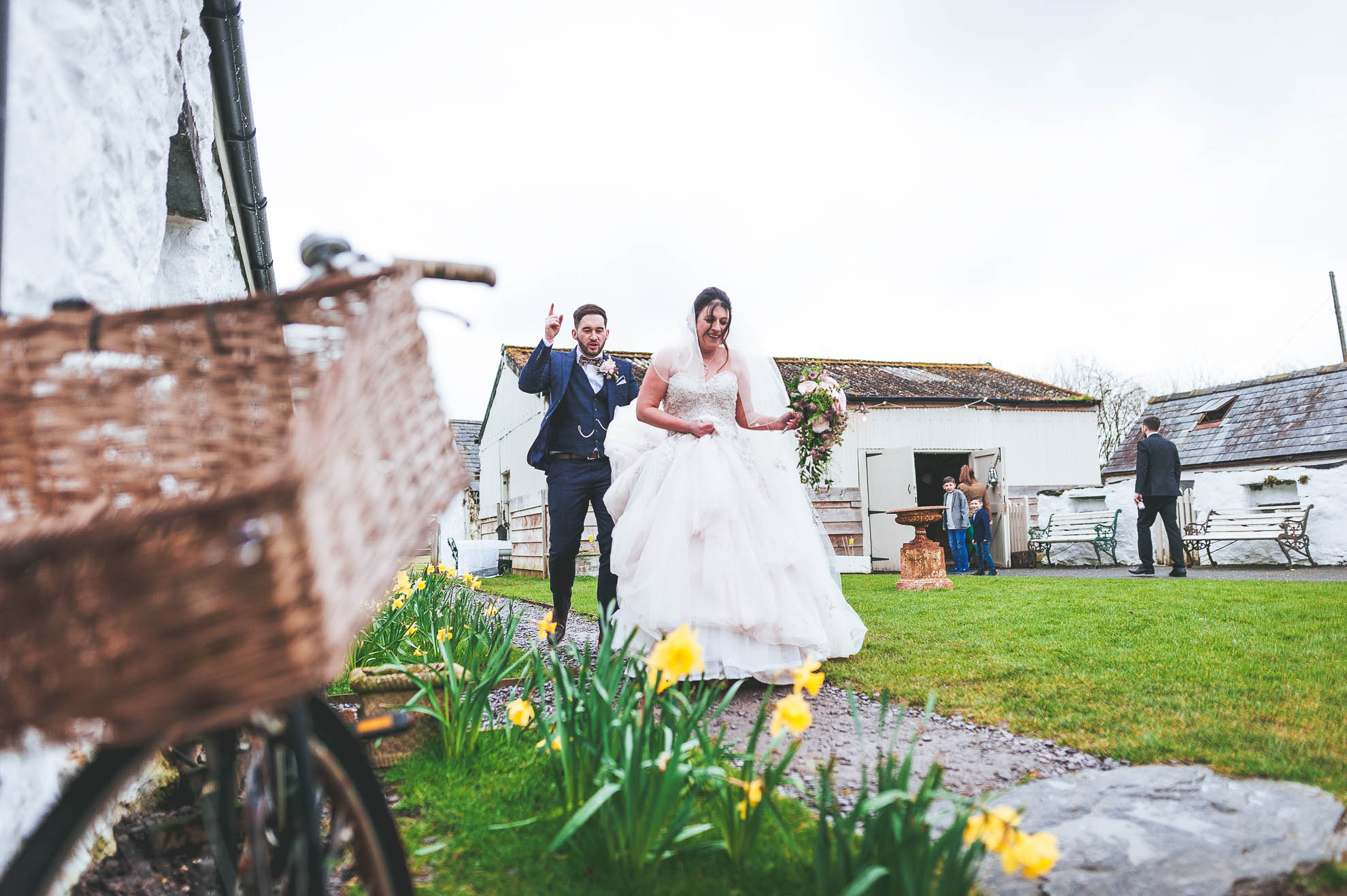 Brid e and groom walk best the barn
