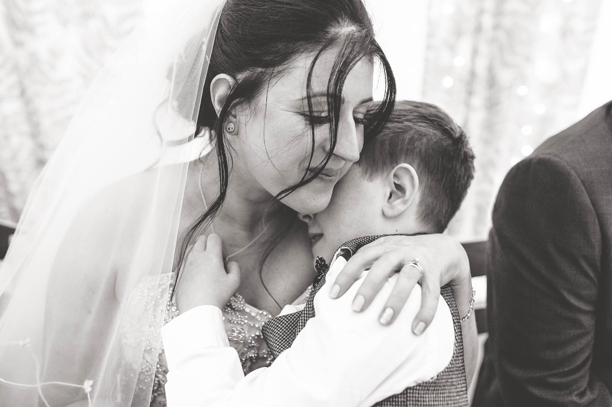 Bride gives son a hug