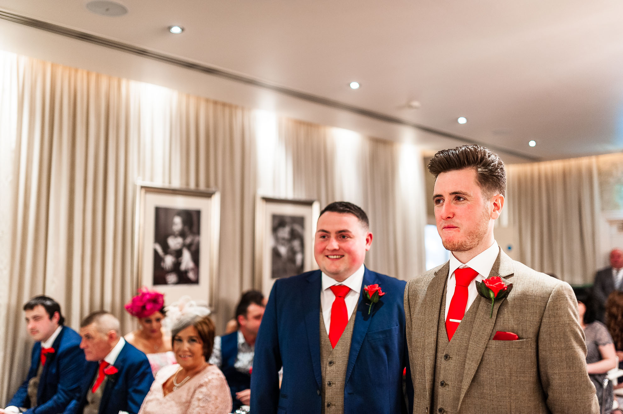 Groom and best man wait in ceremony room