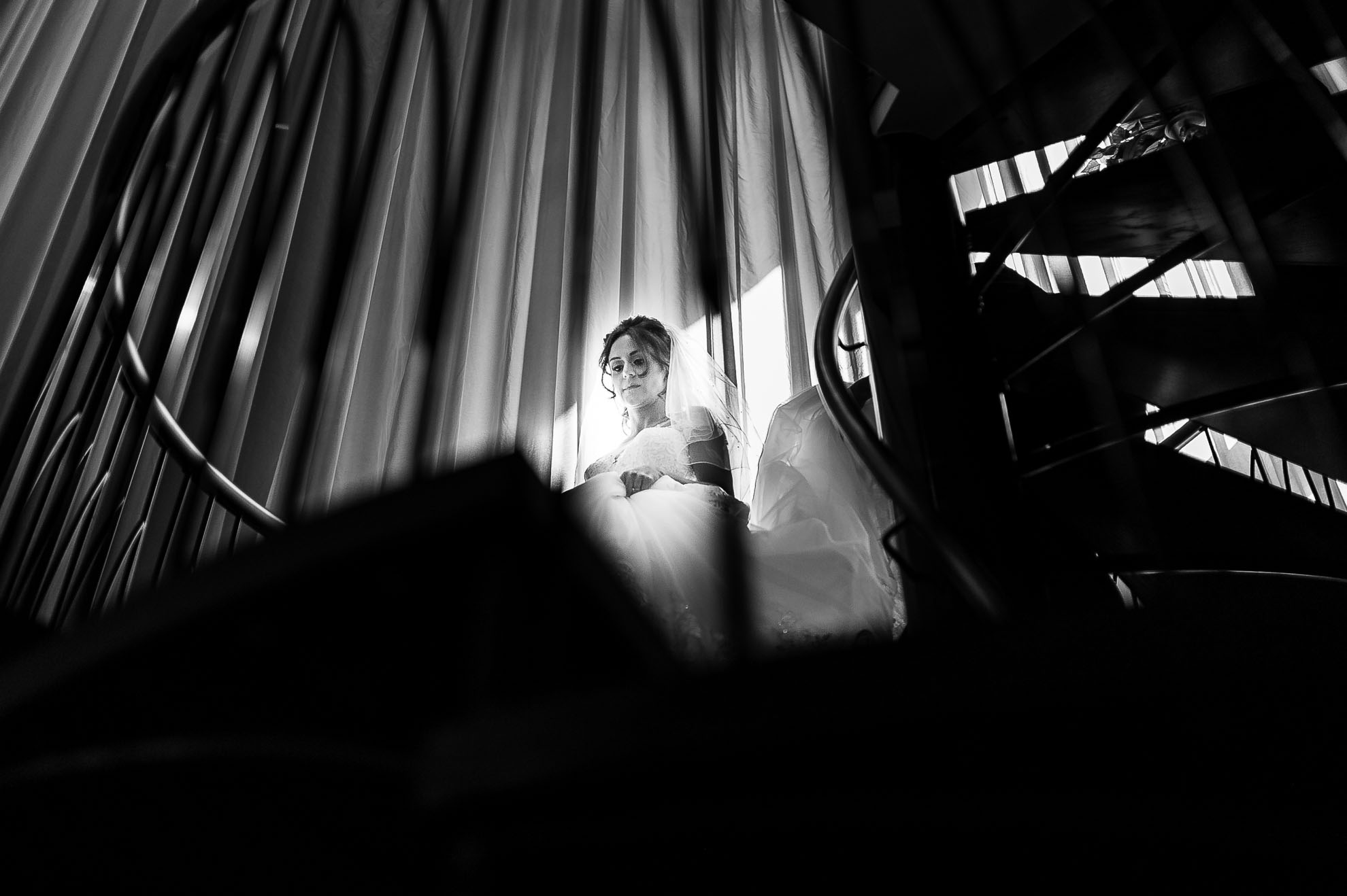 Bride walks down spiral staircase
