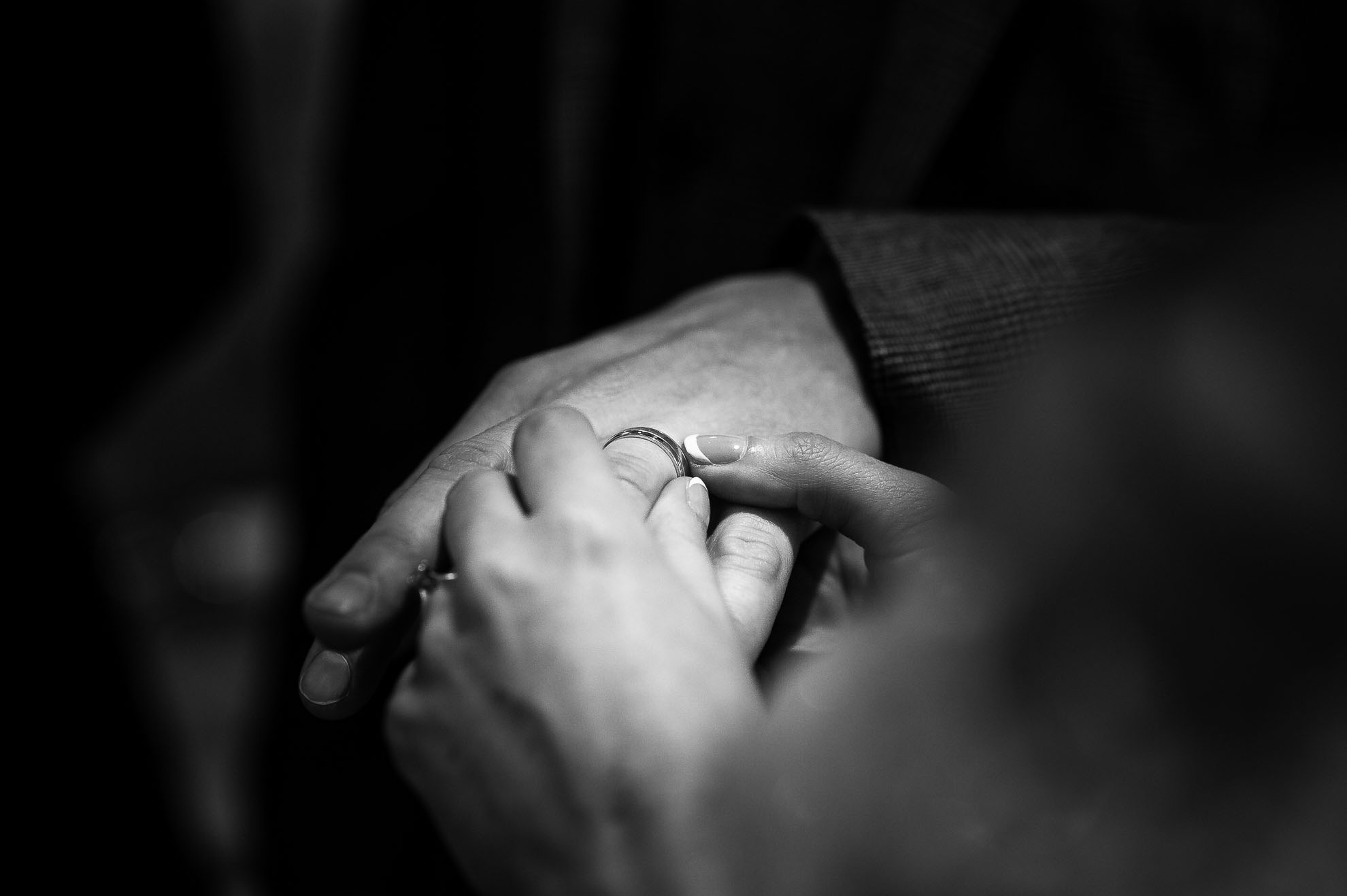 Bride puts ring on groom