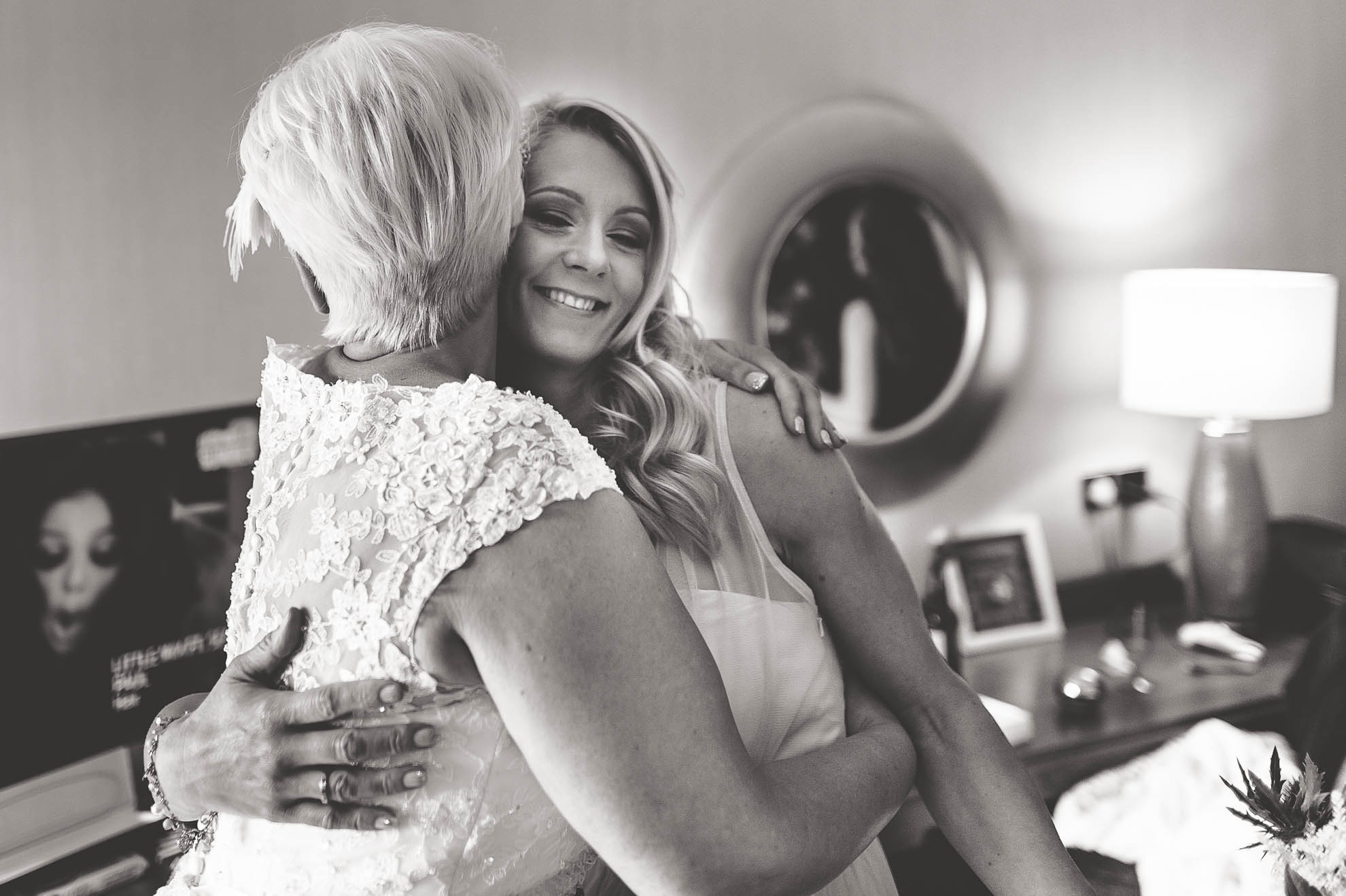 Bride gives bridesmaid a hug