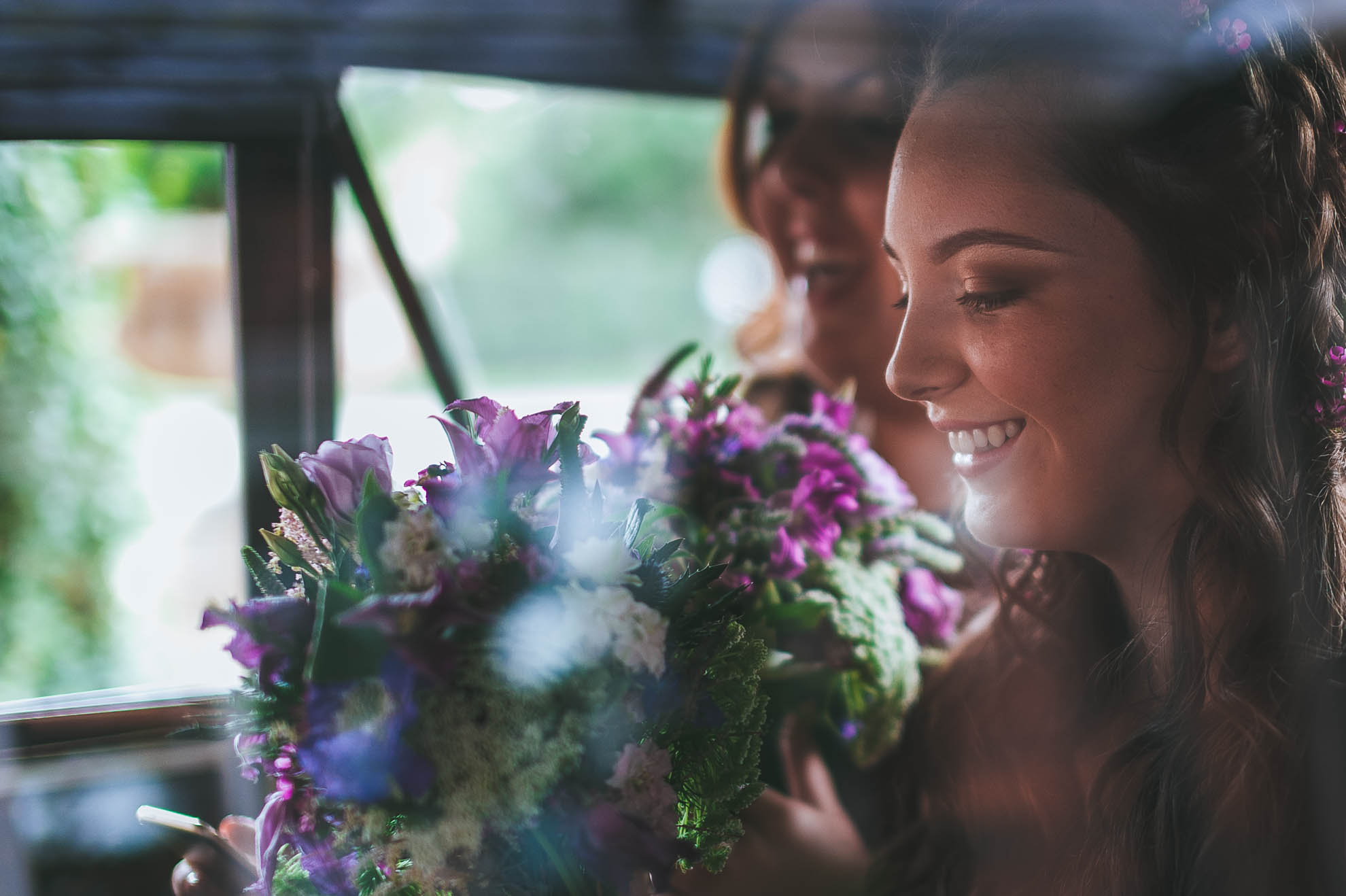 bridesmaids smiling in car