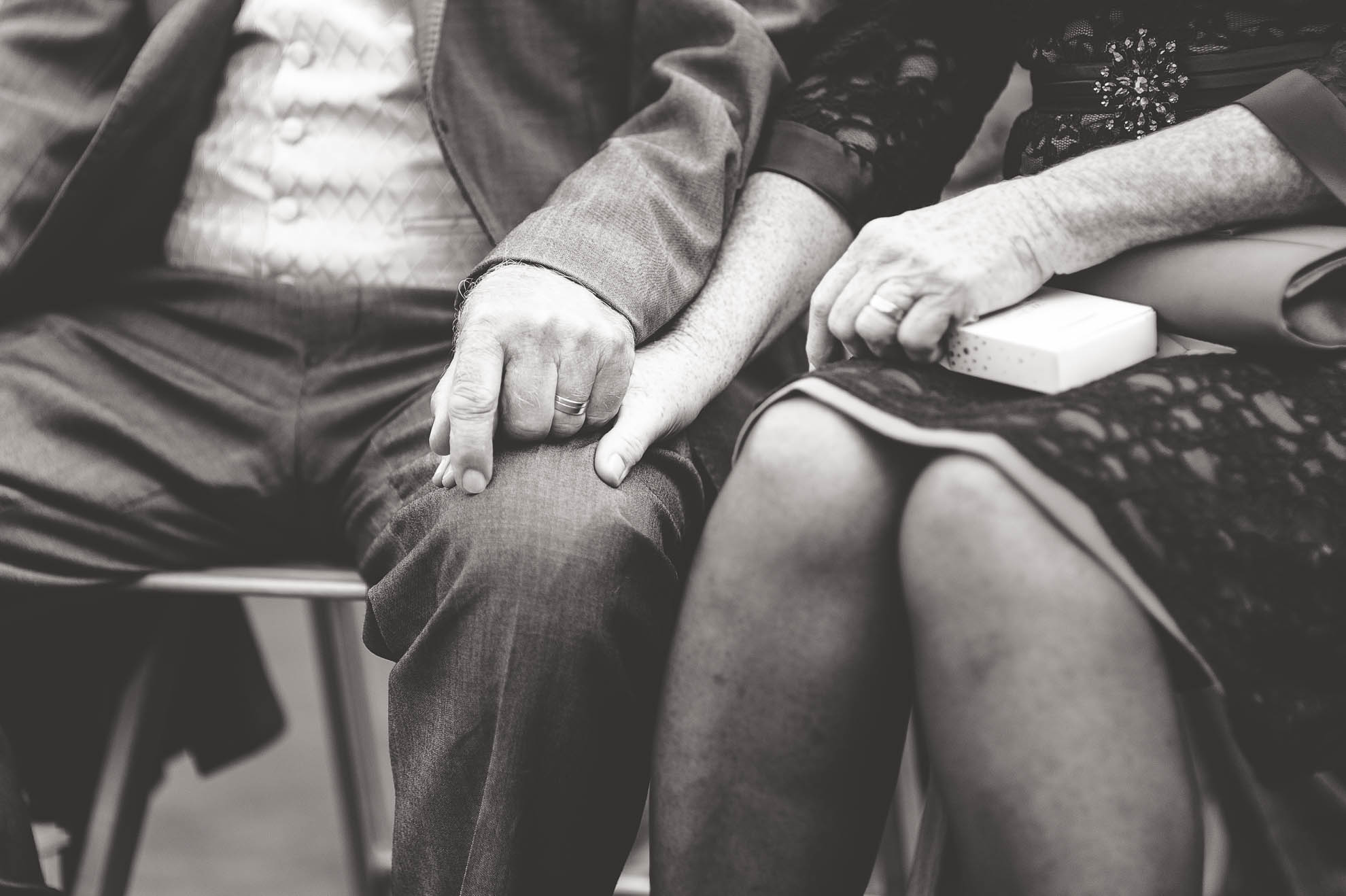 Brides mother and father hold hands