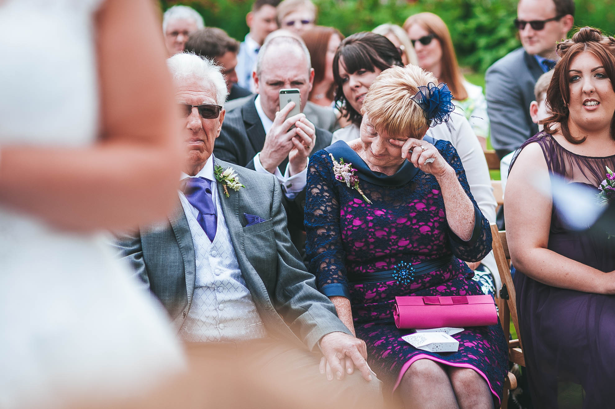 Mother of the bride wipes away a tear