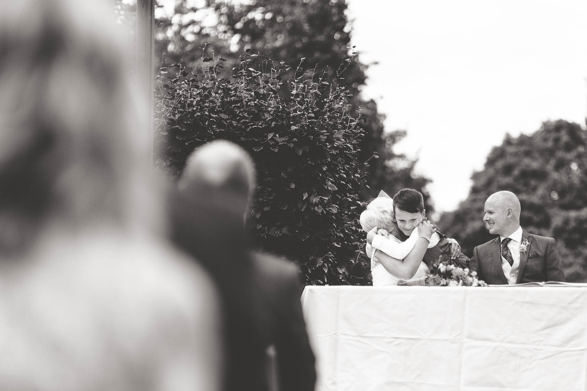 Little boy hugs the bride