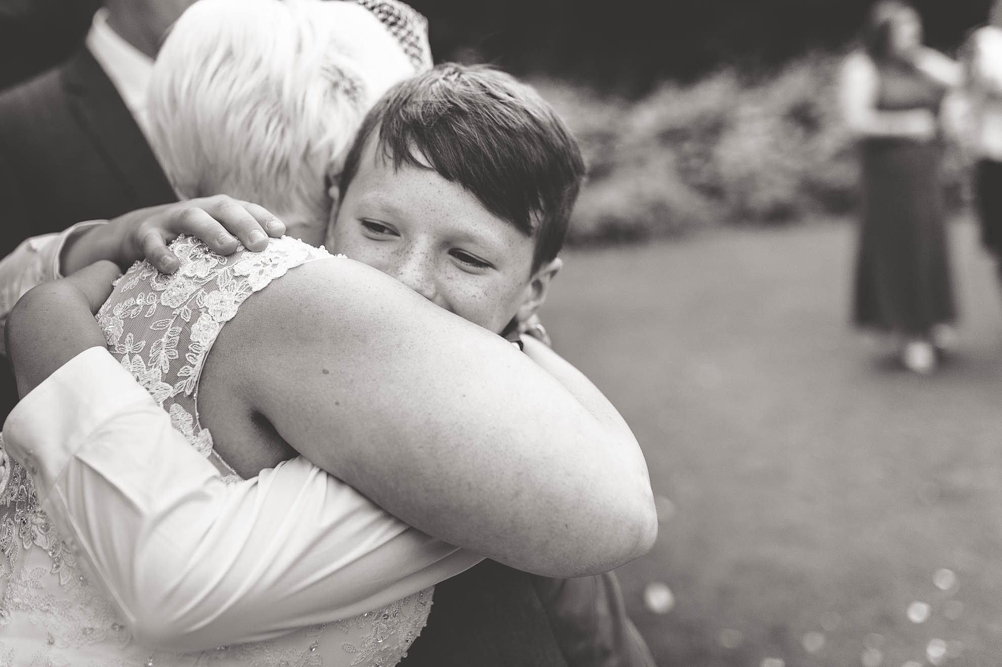 little boy hugs bride