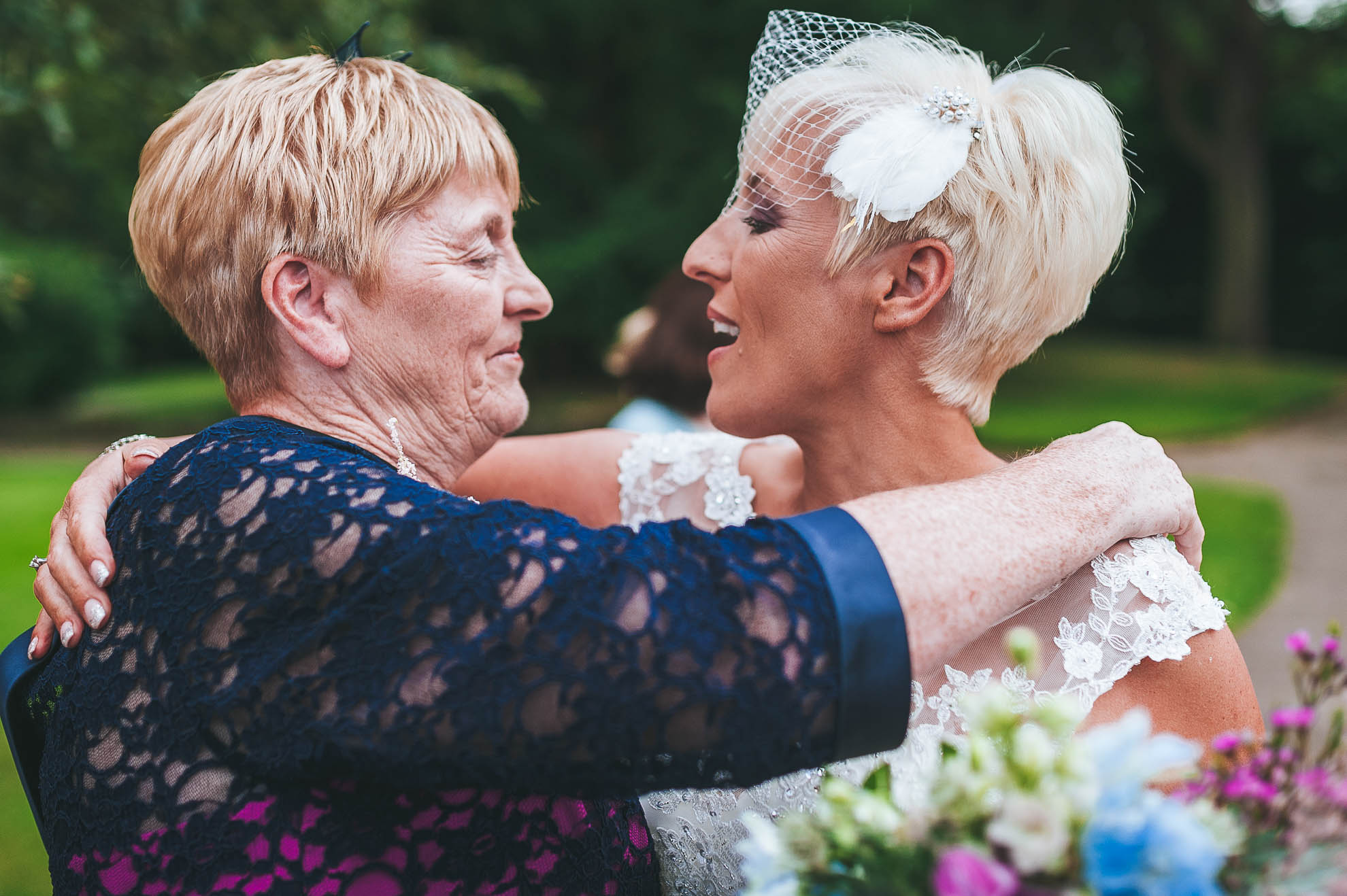 Bride and her mother hug