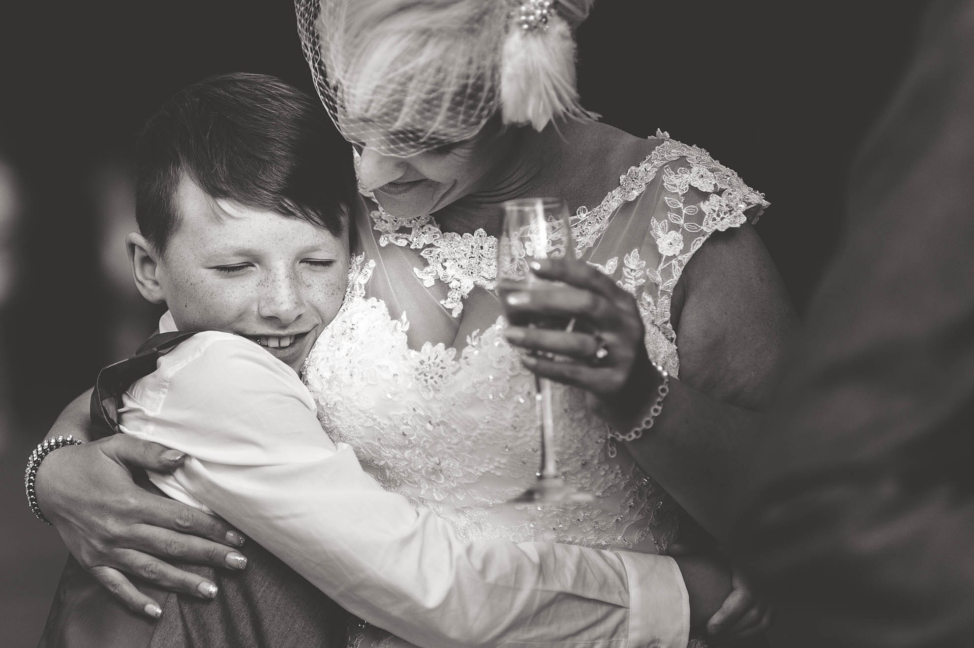 Little boy hugs bride