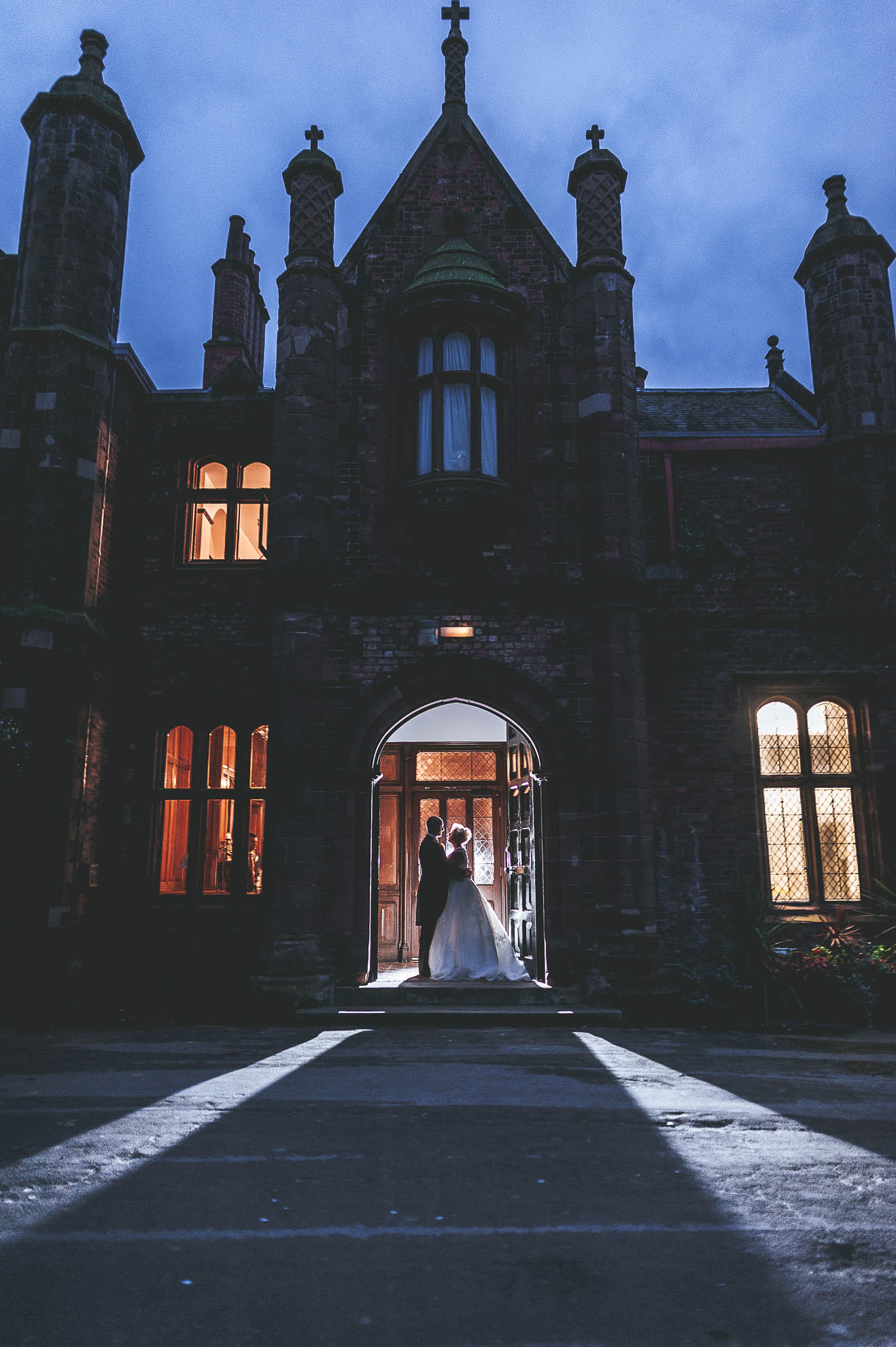Bride and groom portrait in front of Walton Hall