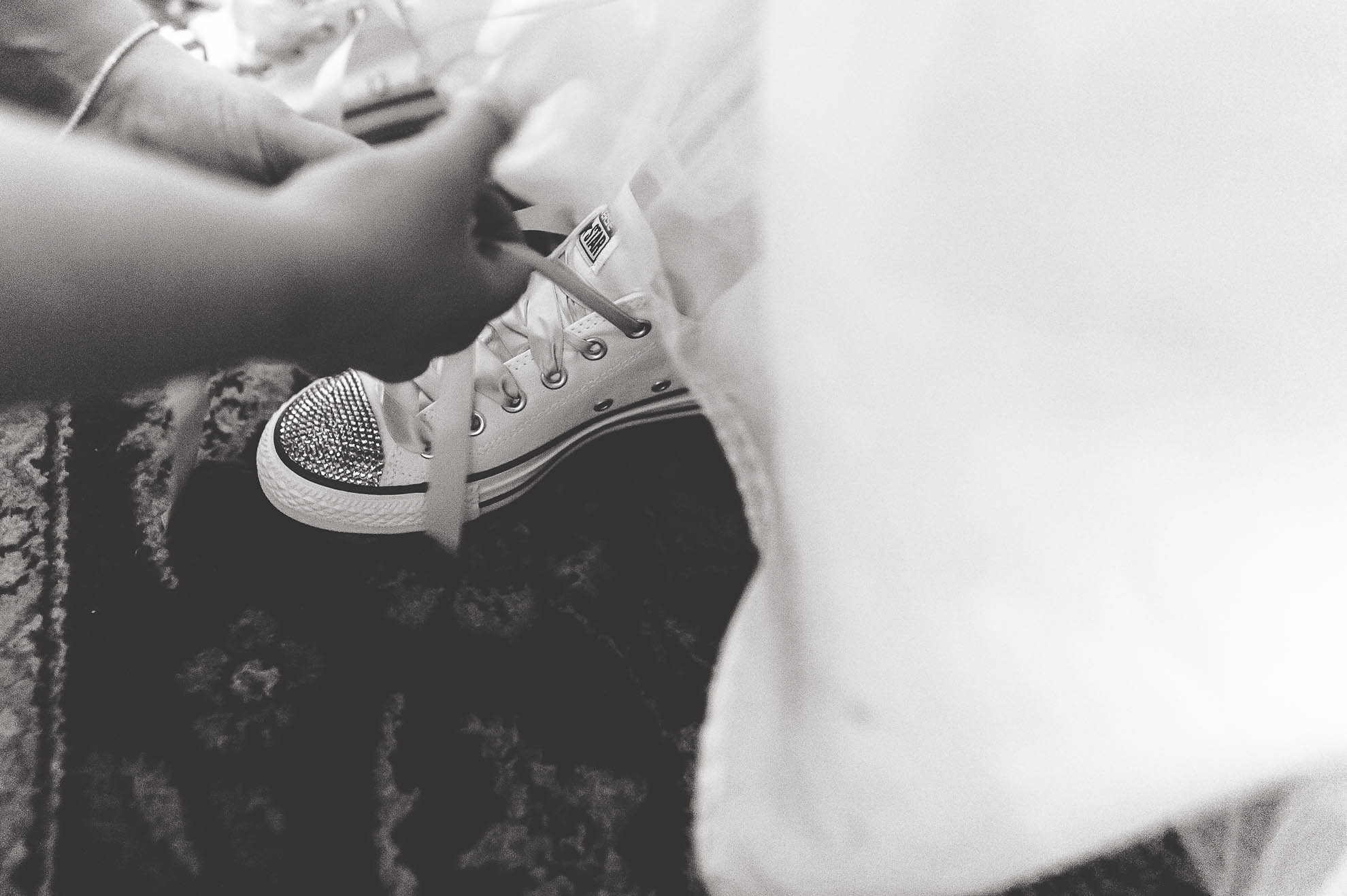 Bride changes into a pair of Converse baseball shoes