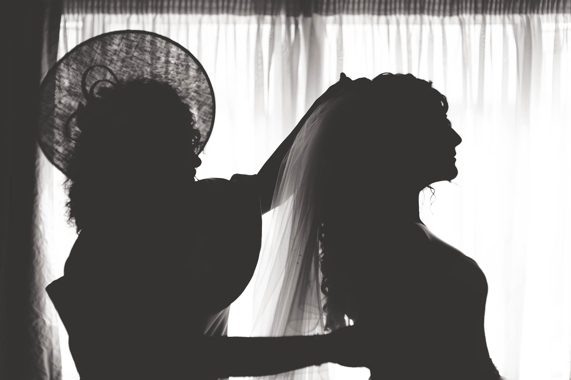 Brides mother adjusting the veil