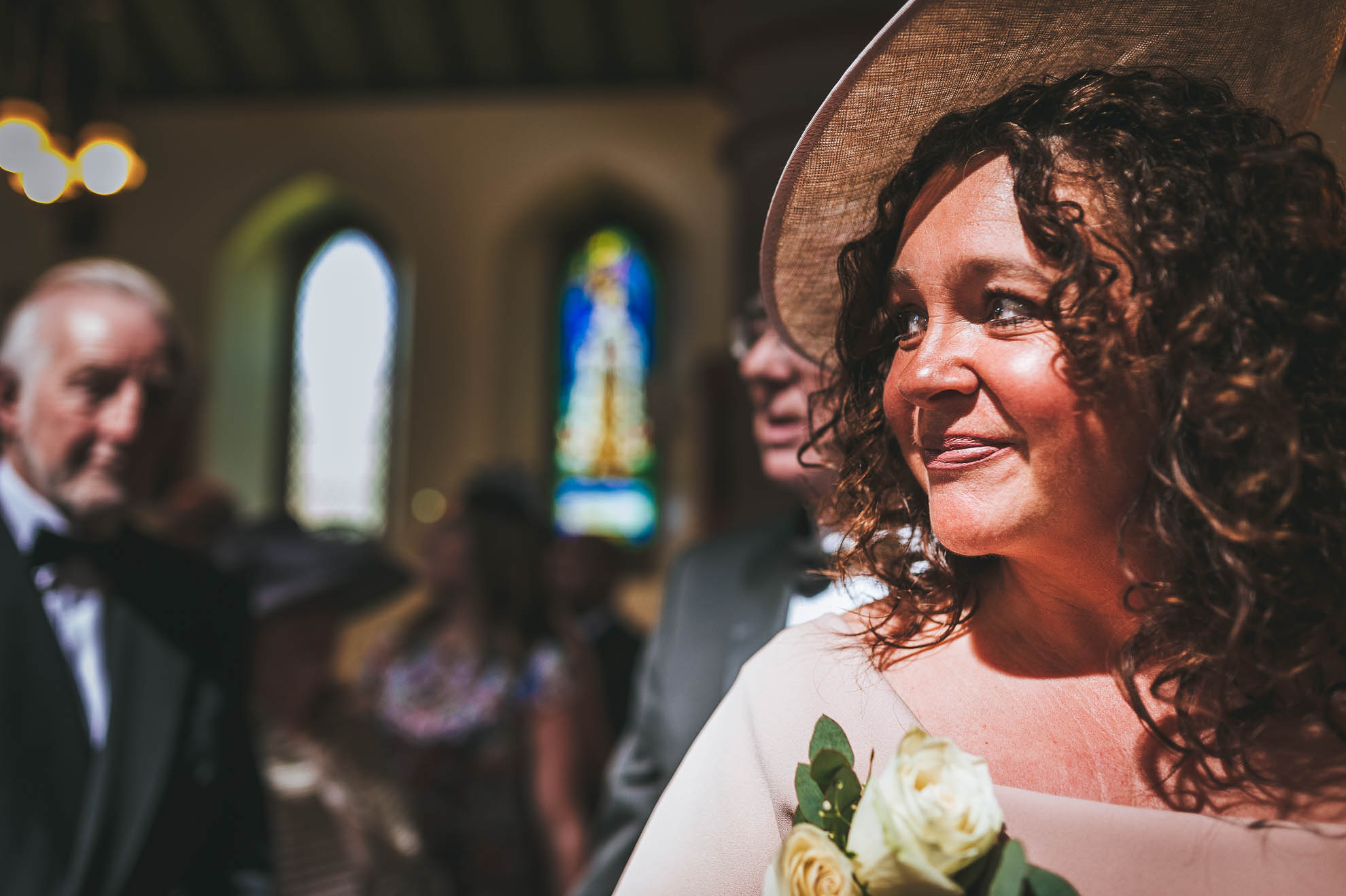 Mother of the bride watches her daughter walk up the aisle
