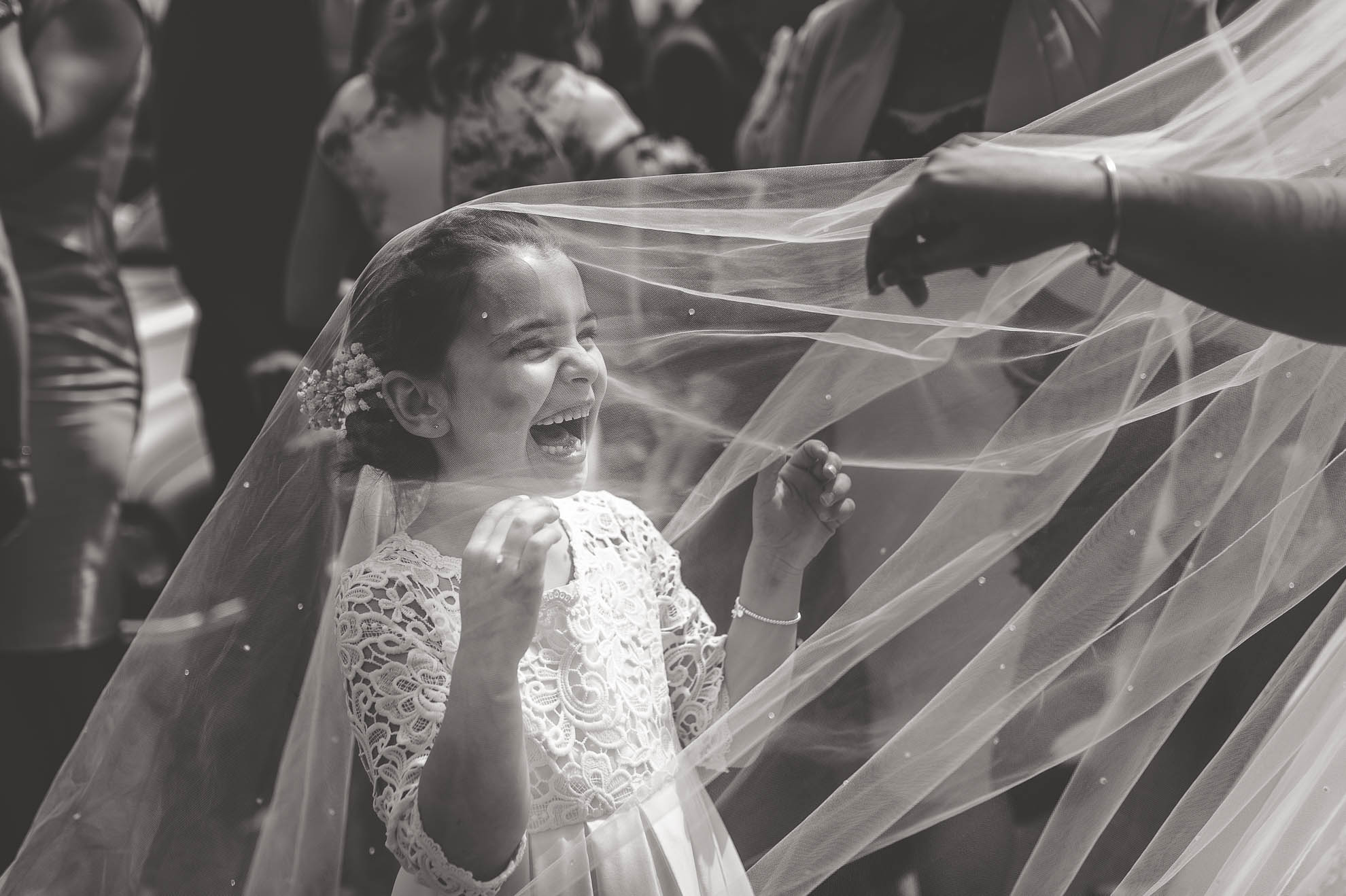 Flower girl plays under veil