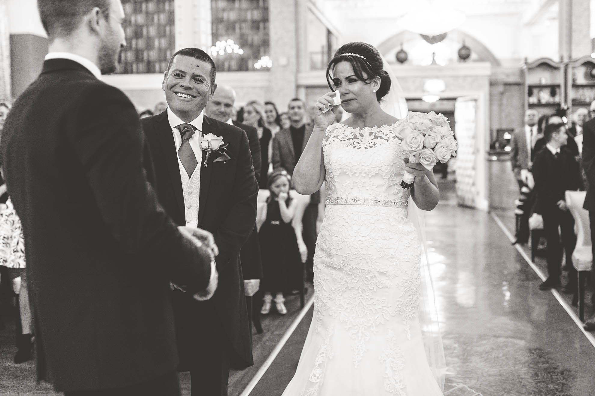 Bride sheds a tear as she walks up aisle