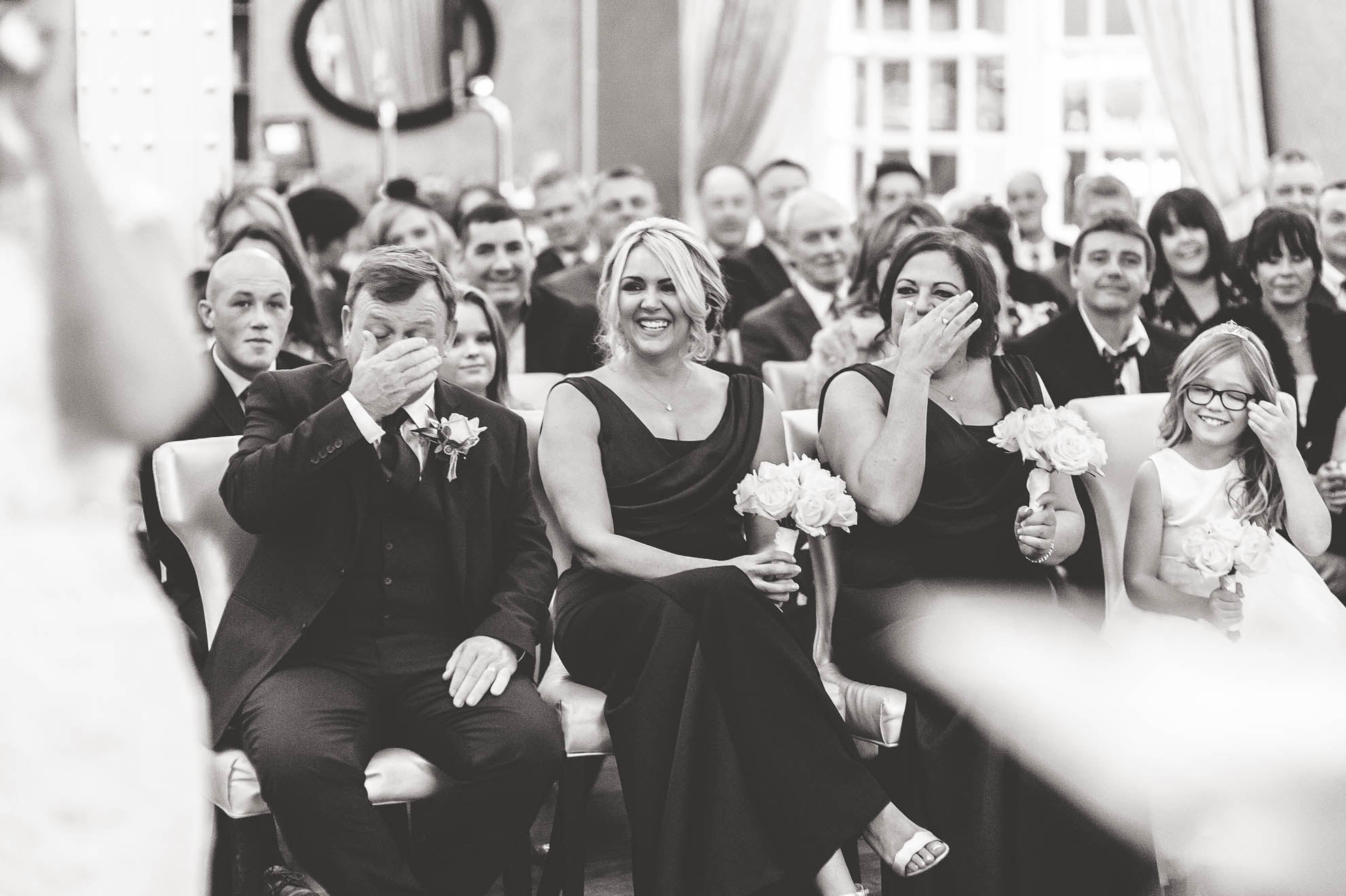 Bridesmaids shedding a tear after newlyweds being announced husband and wife