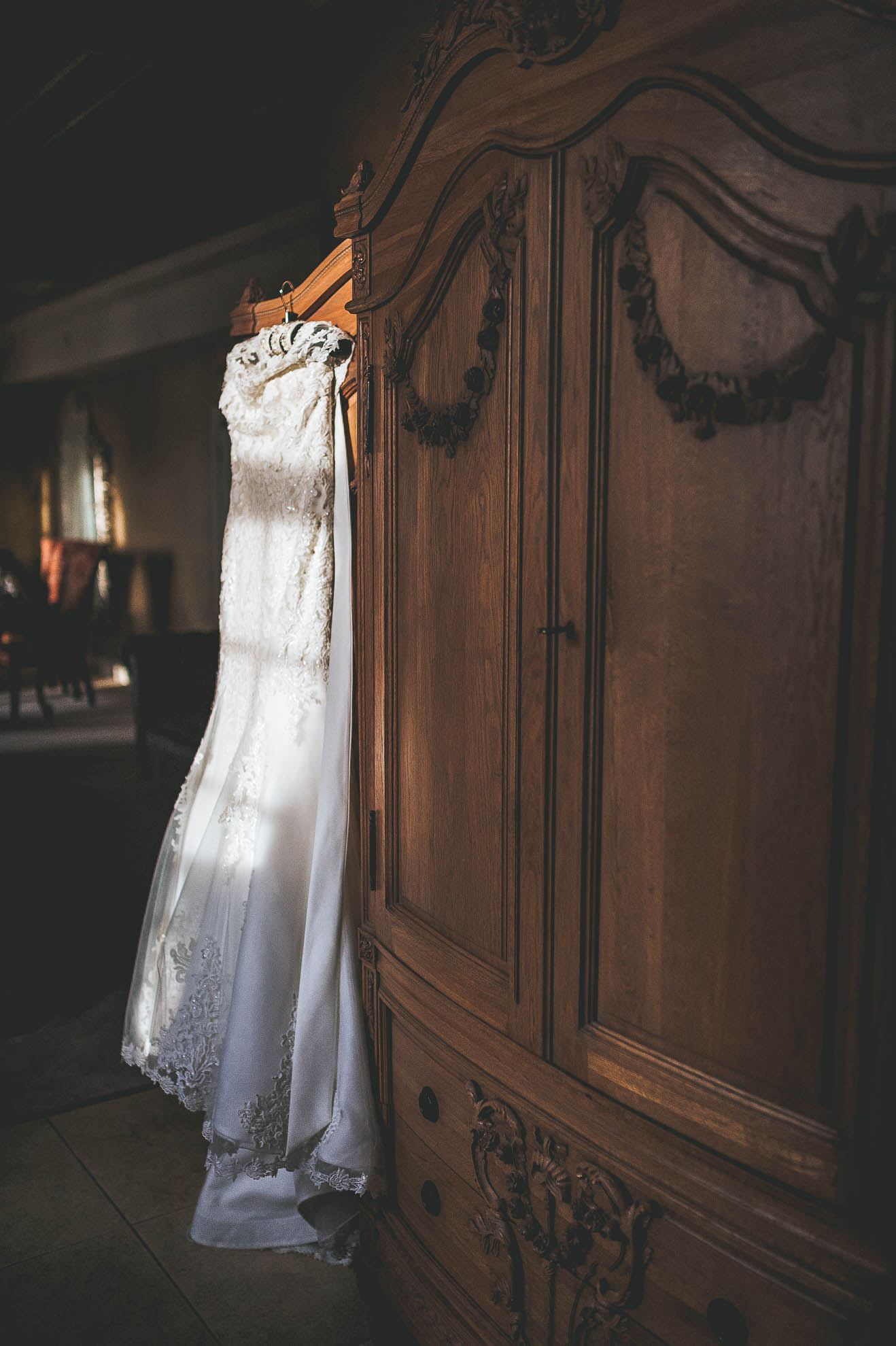 wedding dress hanging on wardrobe