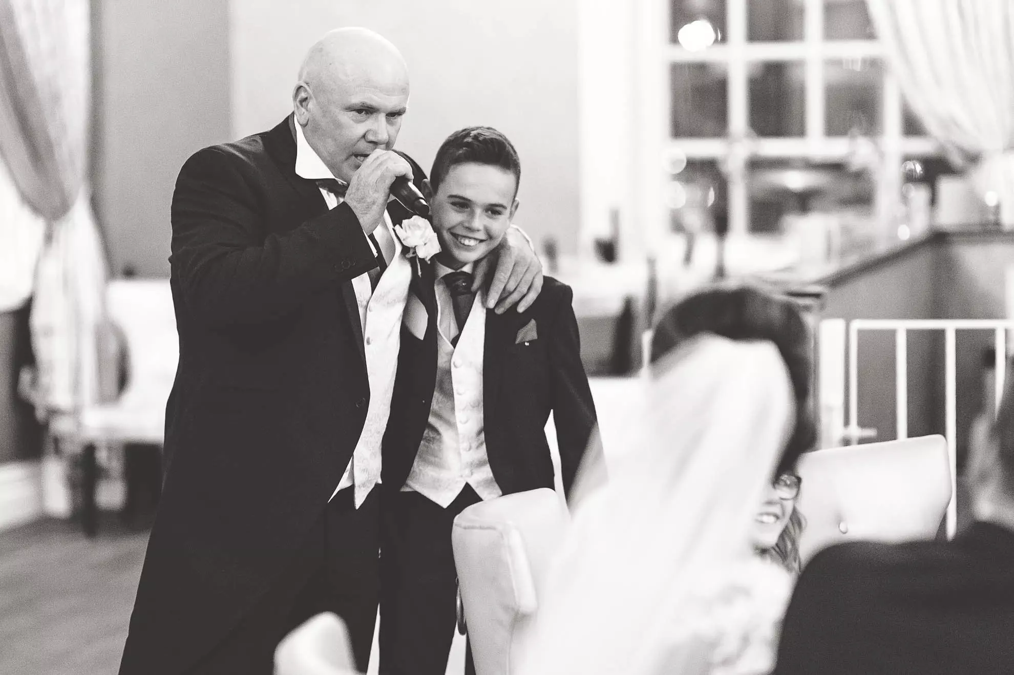 Best man and page boy share a joke during the speeches