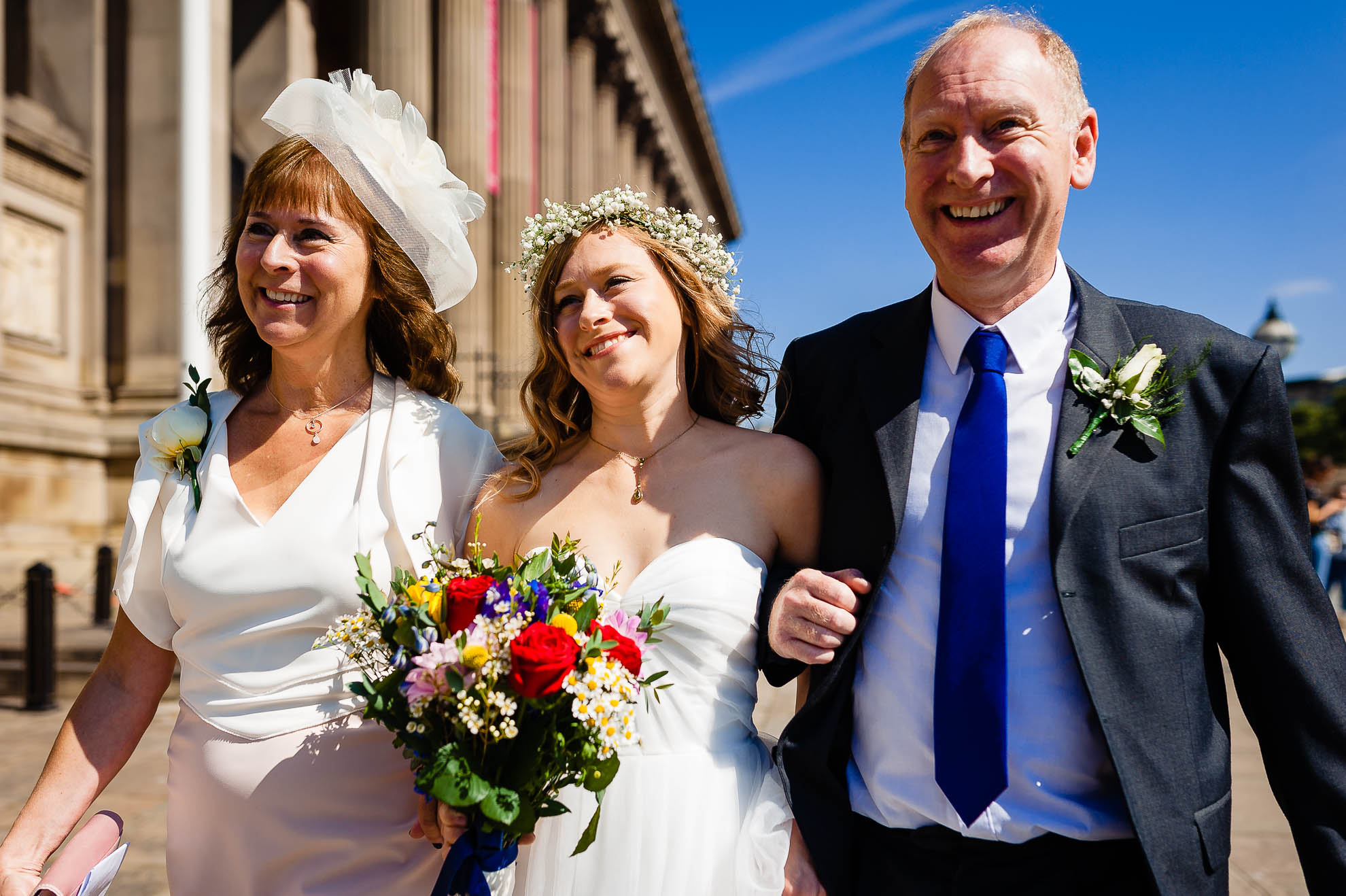 Bride and her mother & father walk to St Georges Hall