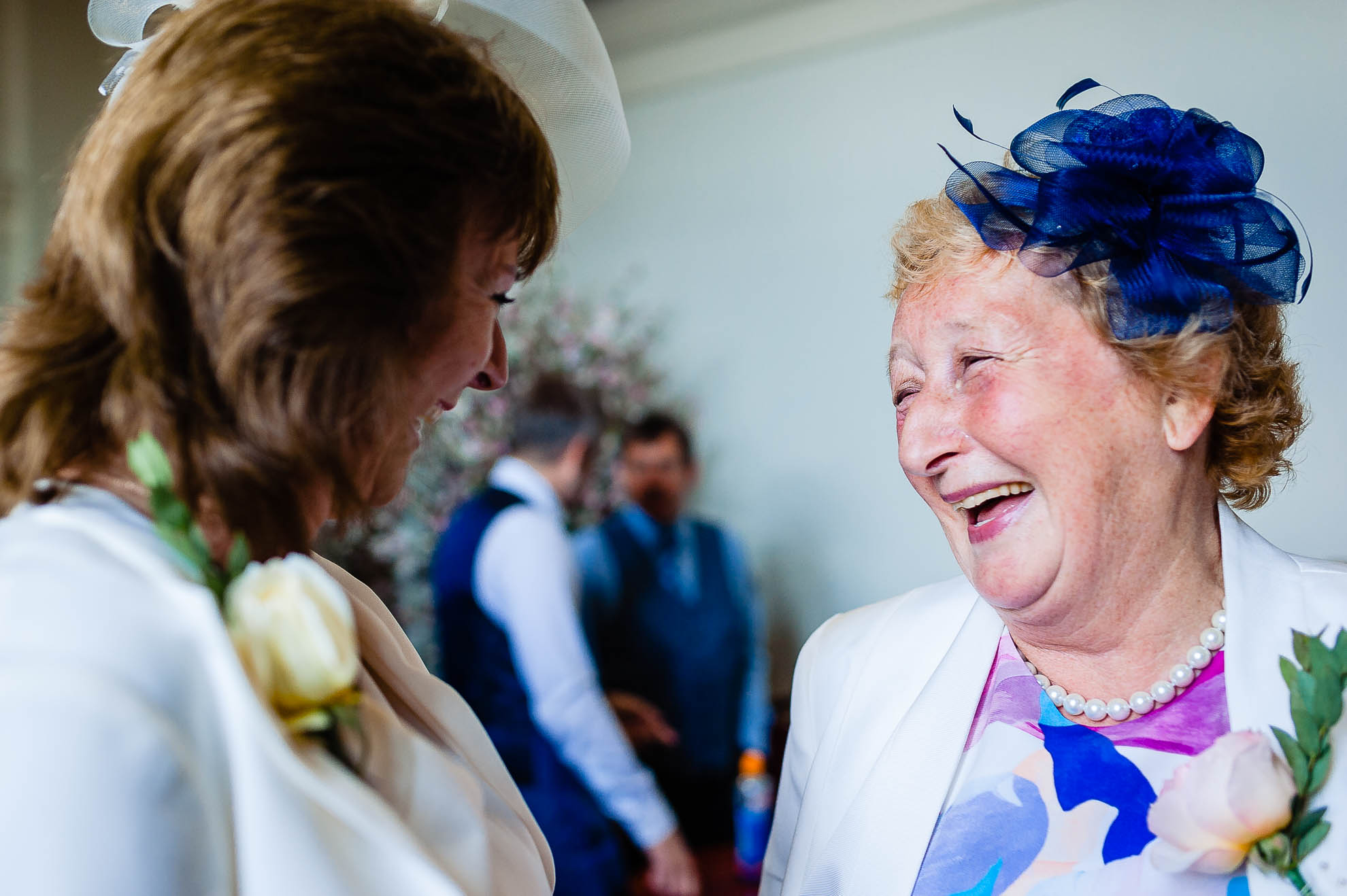 Mother of the groom and mother of the bride share a joke