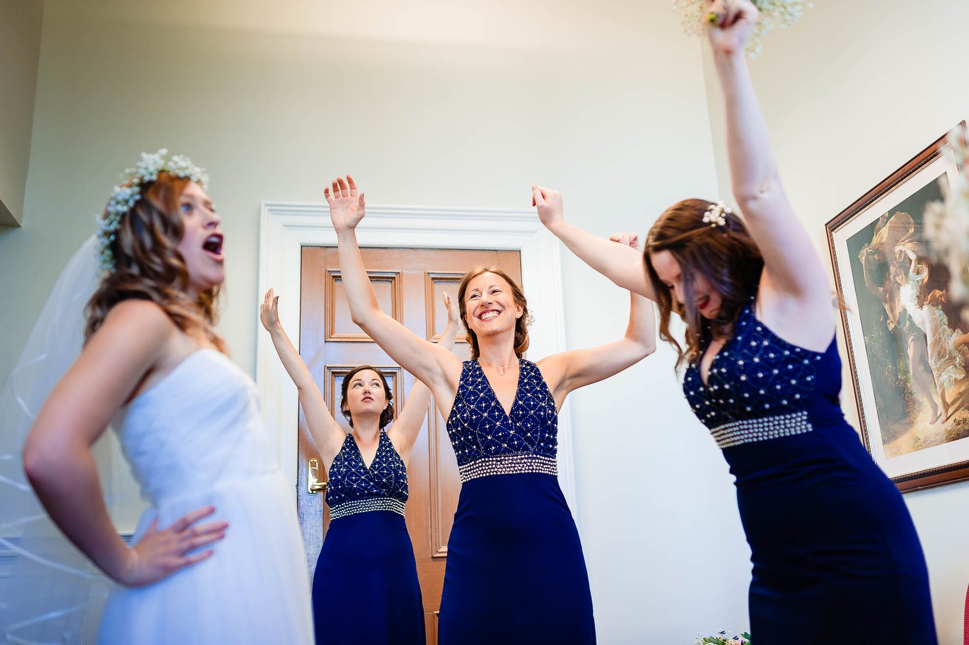 Bride and bridesmaids playing about before the ceremony
