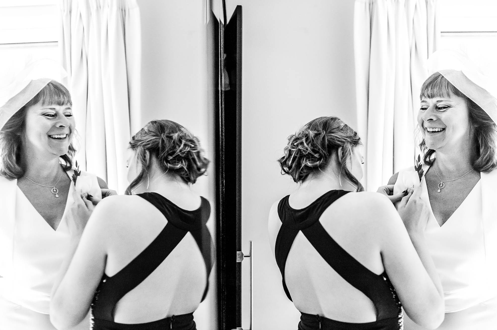 Bridesmaid helps mother of the bride get ready