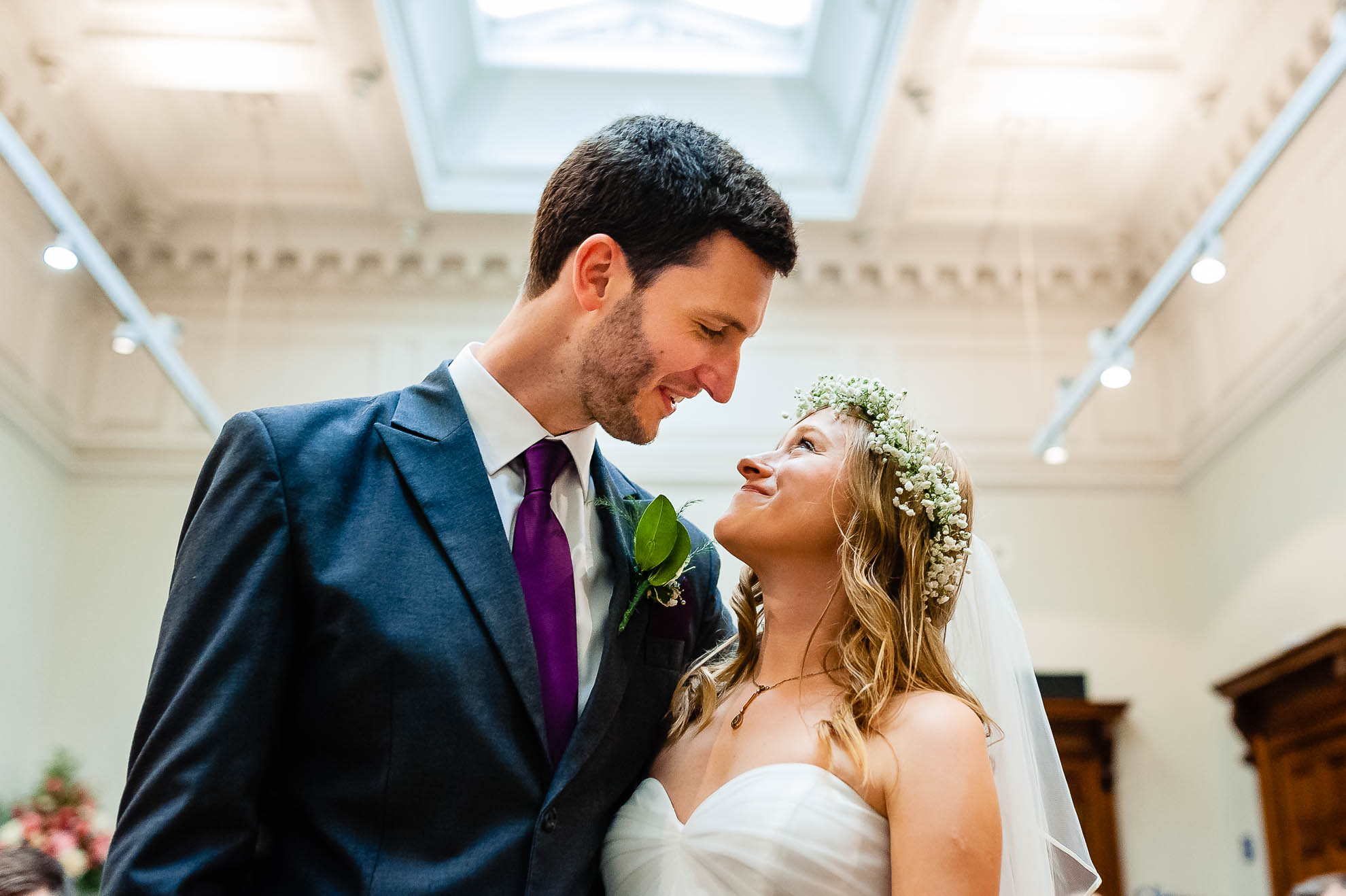 Bride and groom look into each others eyes after the exchange of rings