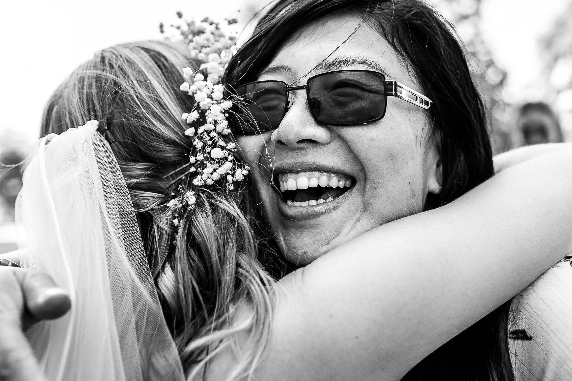Wedding guest hugs bride at drinks reception