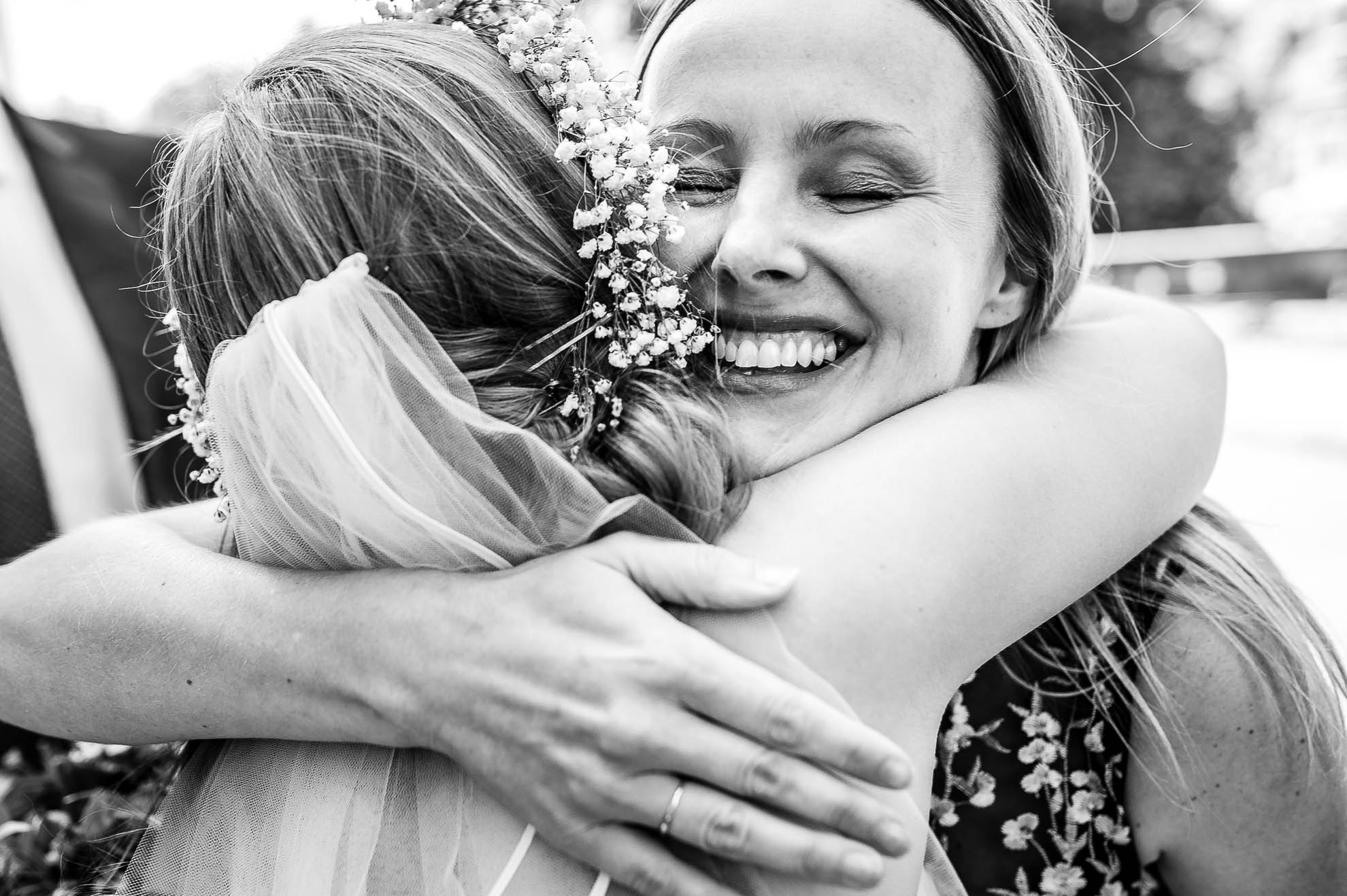 bride hugs guest during drinks reception