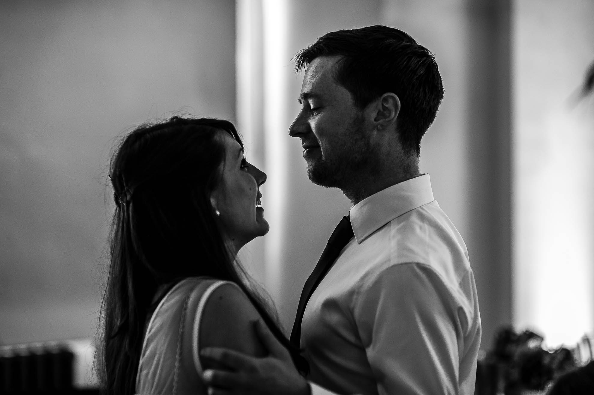 Best man and partner smile at each other