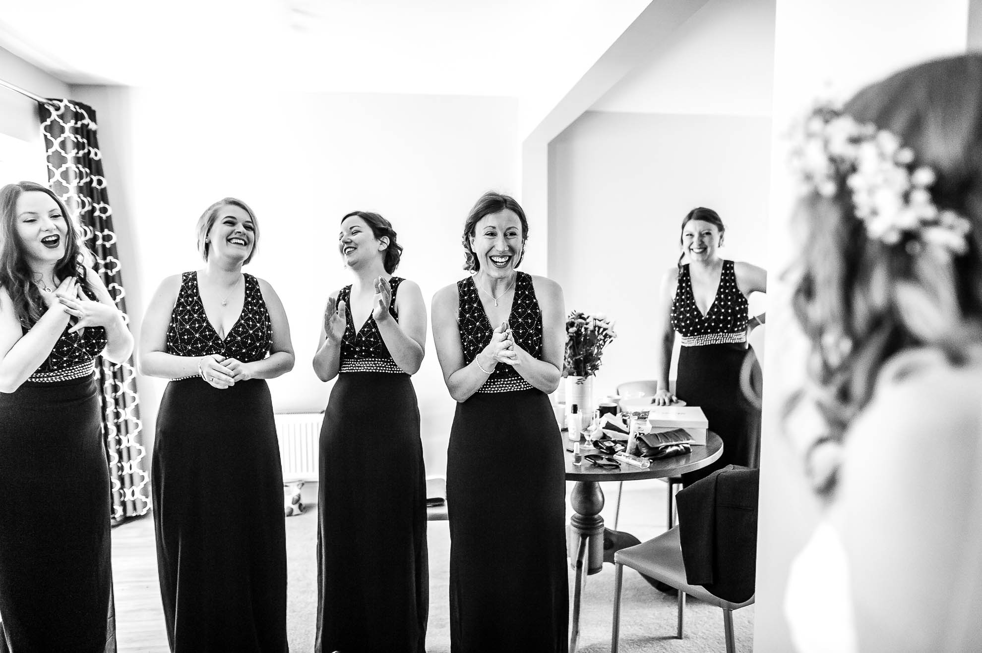 Bridesmaids see the bride in her dress for the first time
