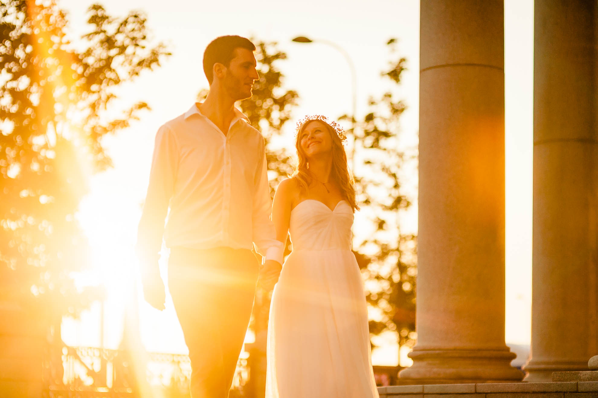 Bride smiles at the groom as they walk past Three Graces