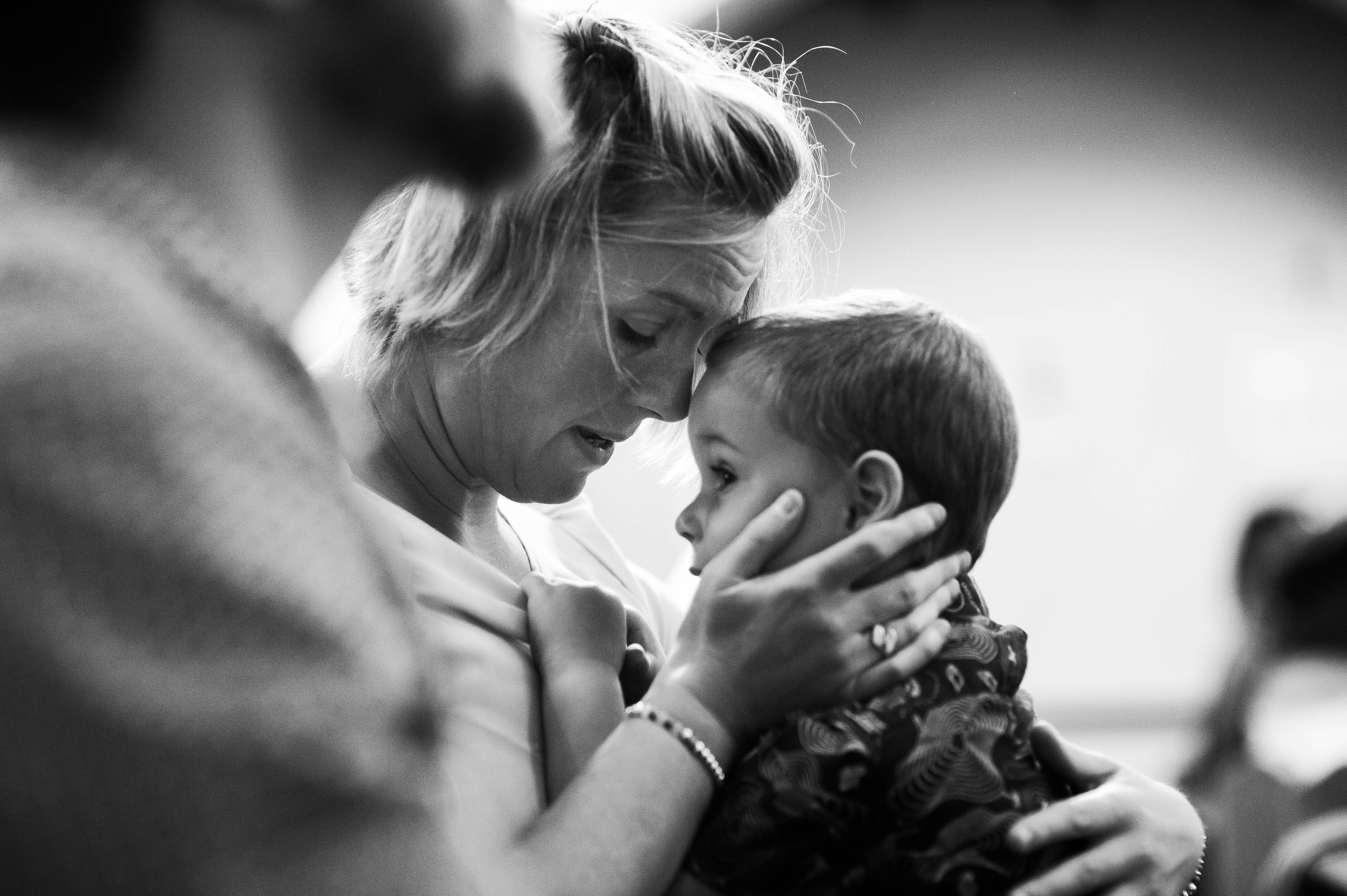 Wedding guest hugs her child