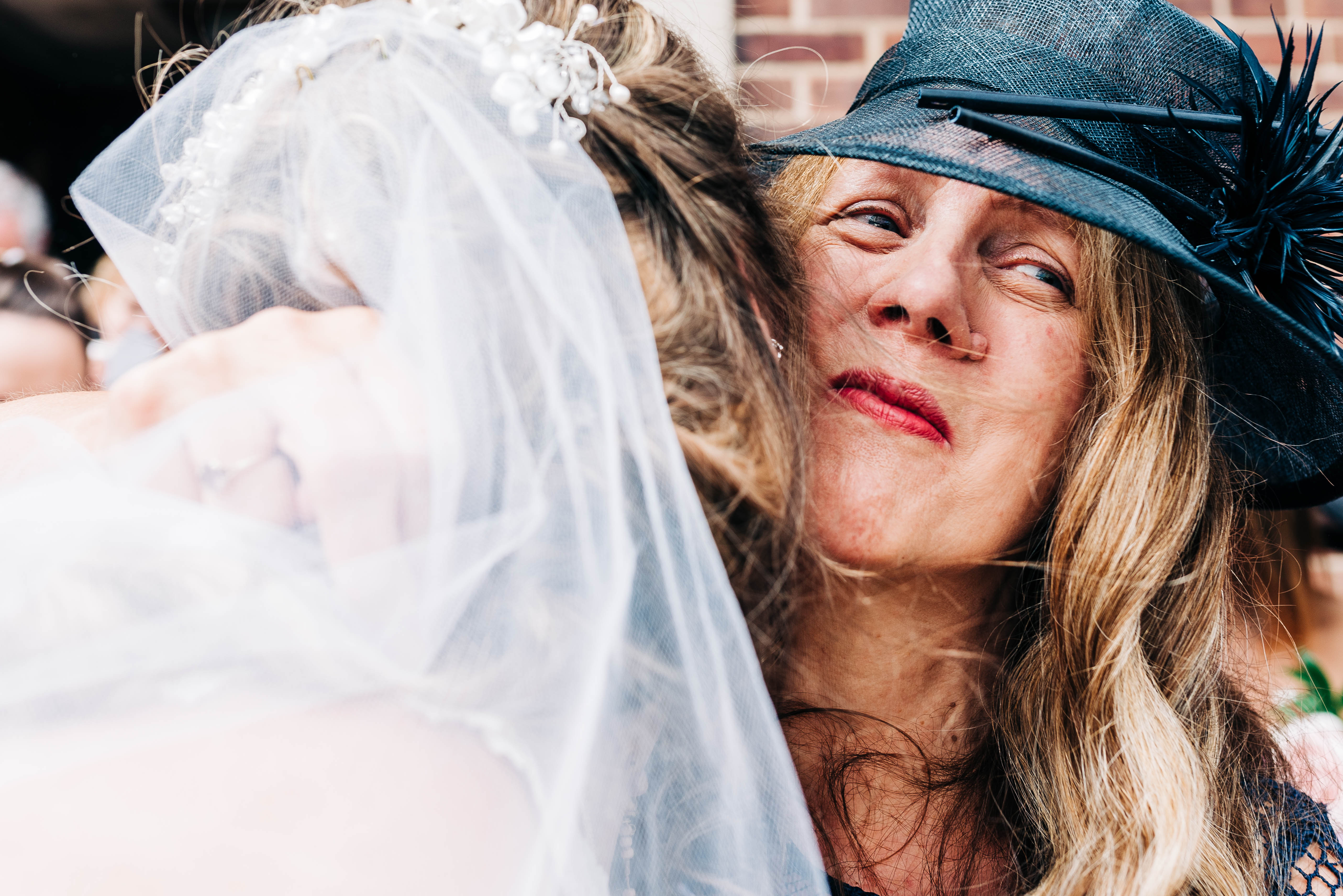 Mother of the groom hugs the bride