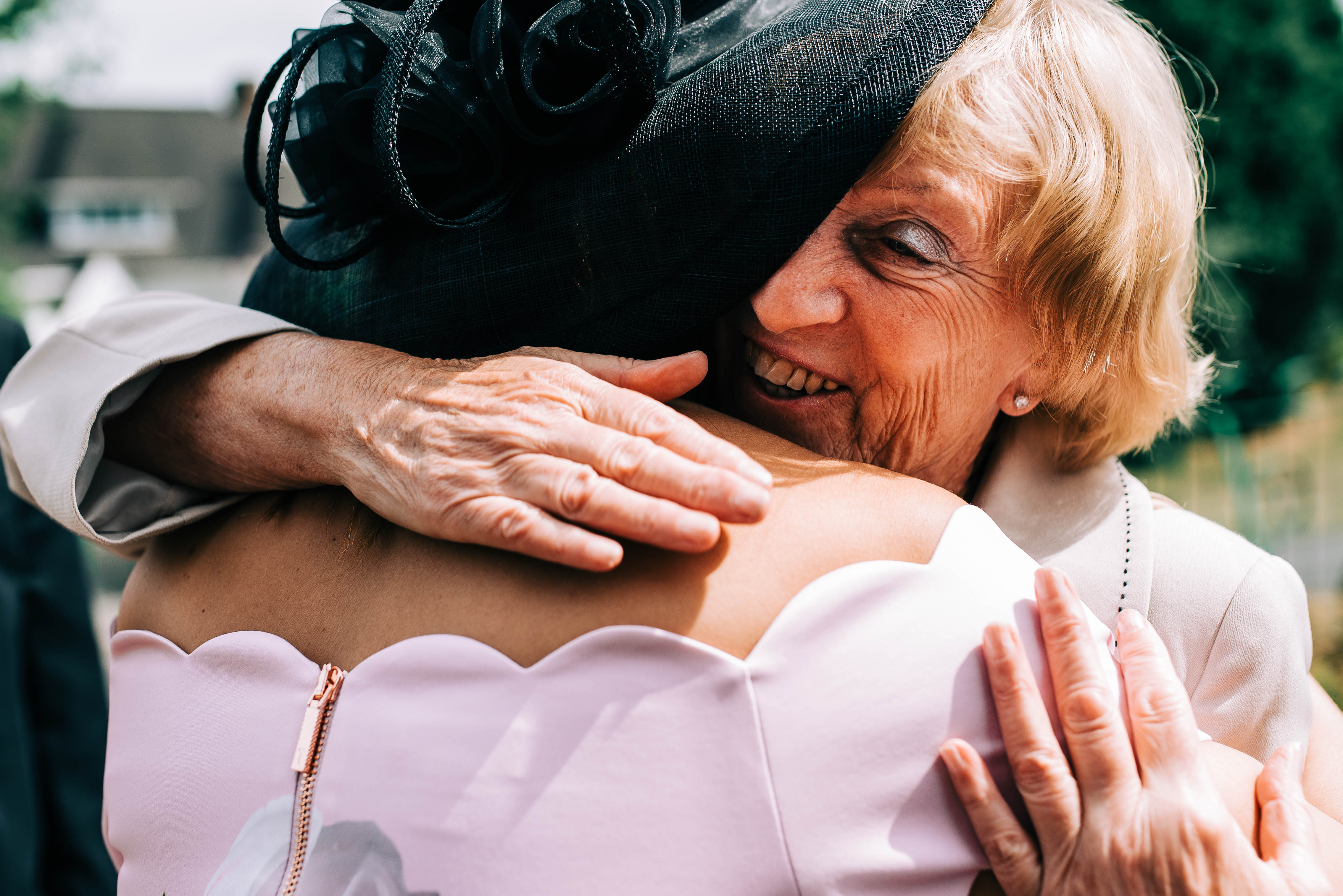 Wedding guest hugs mother of the bride