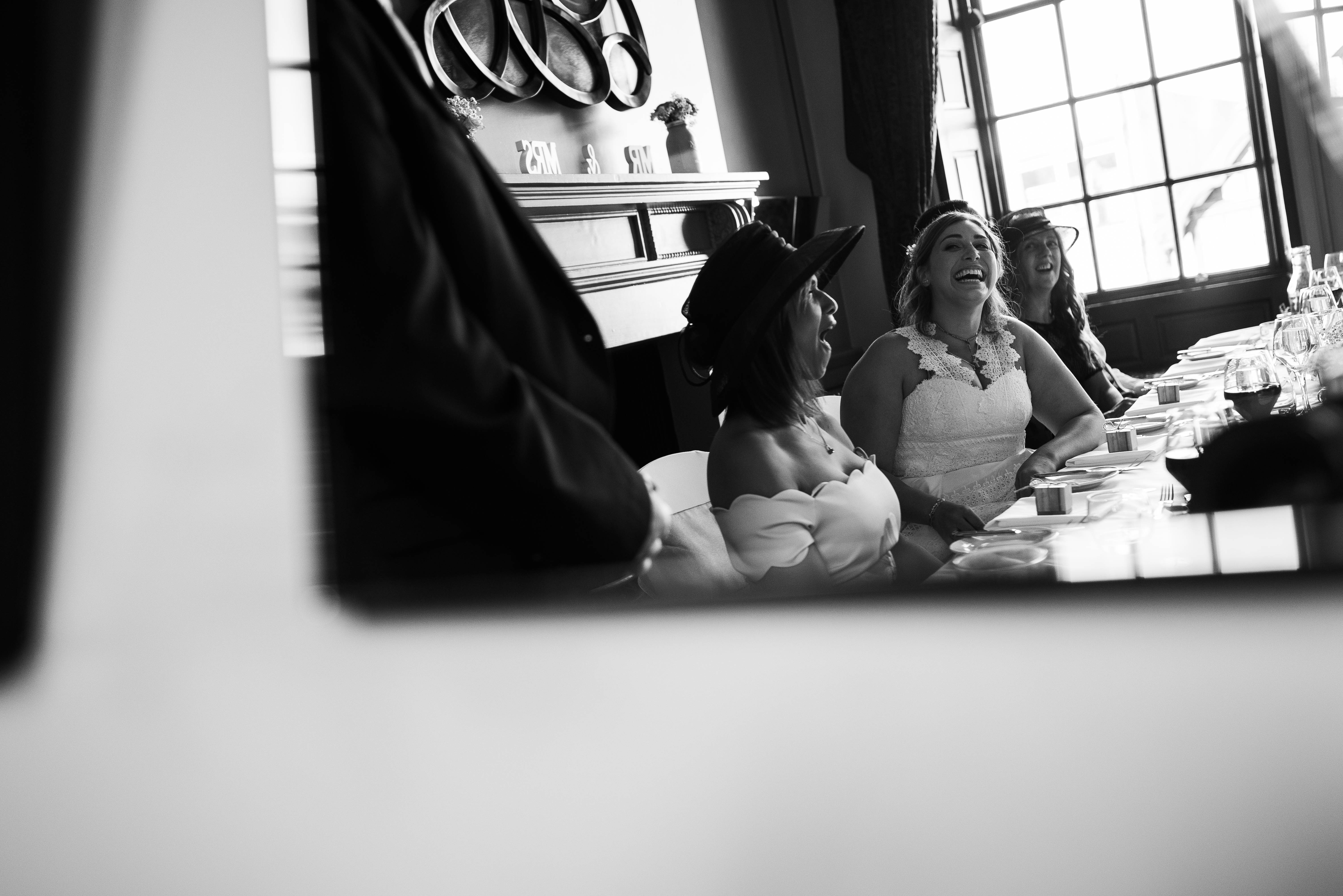 Bride laughs at a joke during father of the brides speech