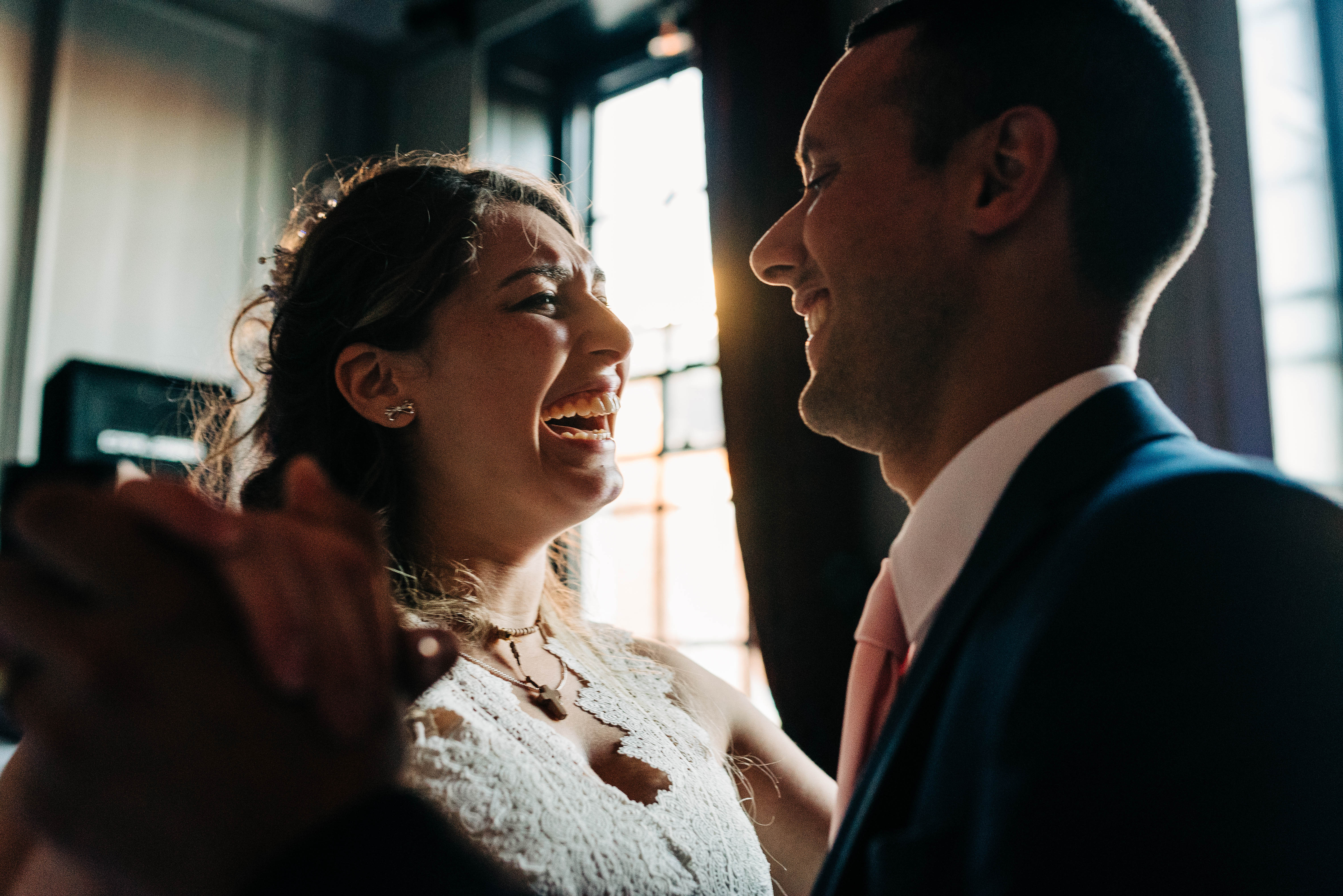 Bride and groom laugh during first dance