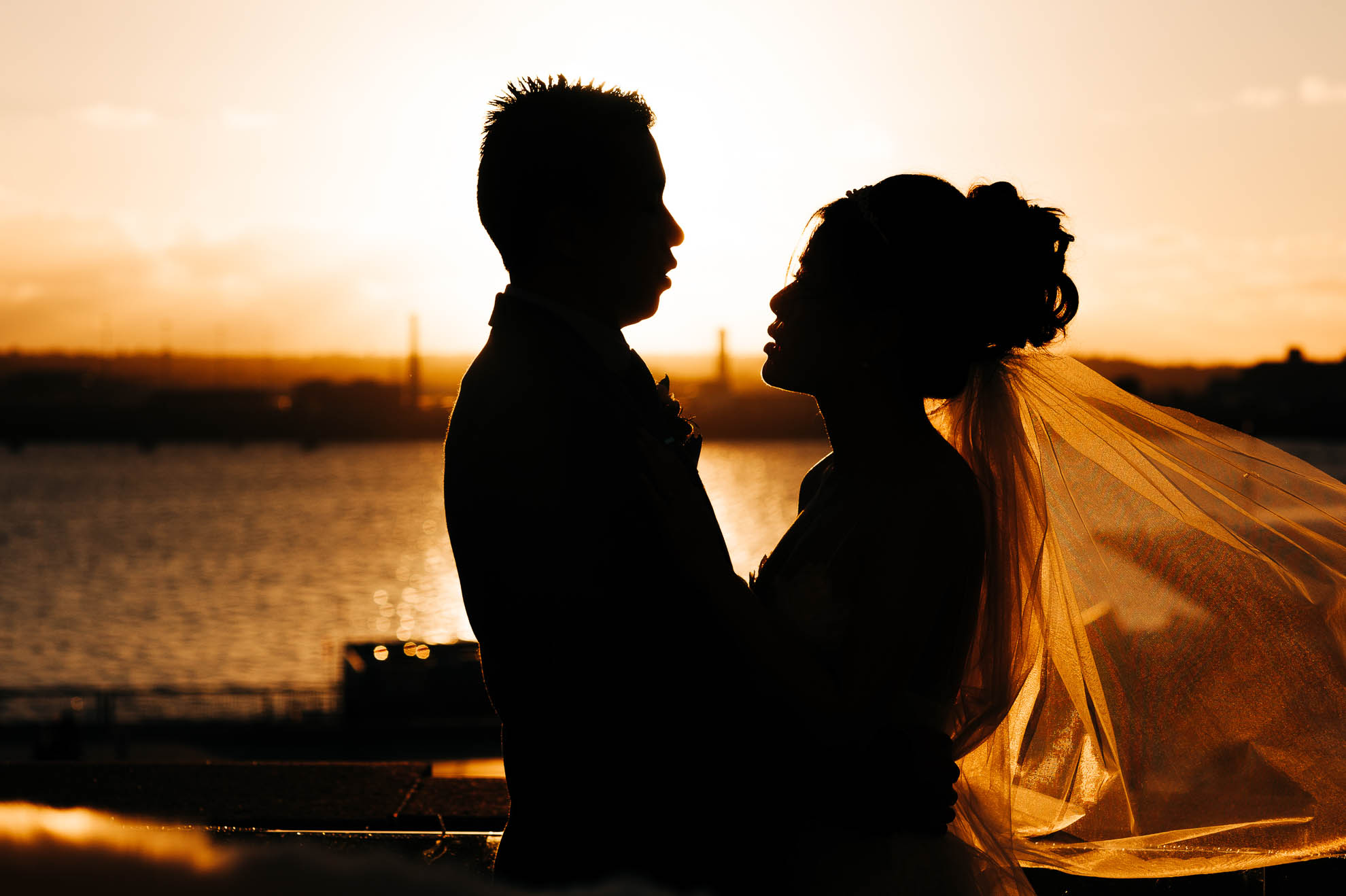 Bride and groom silhouette on rooftop of Liver building